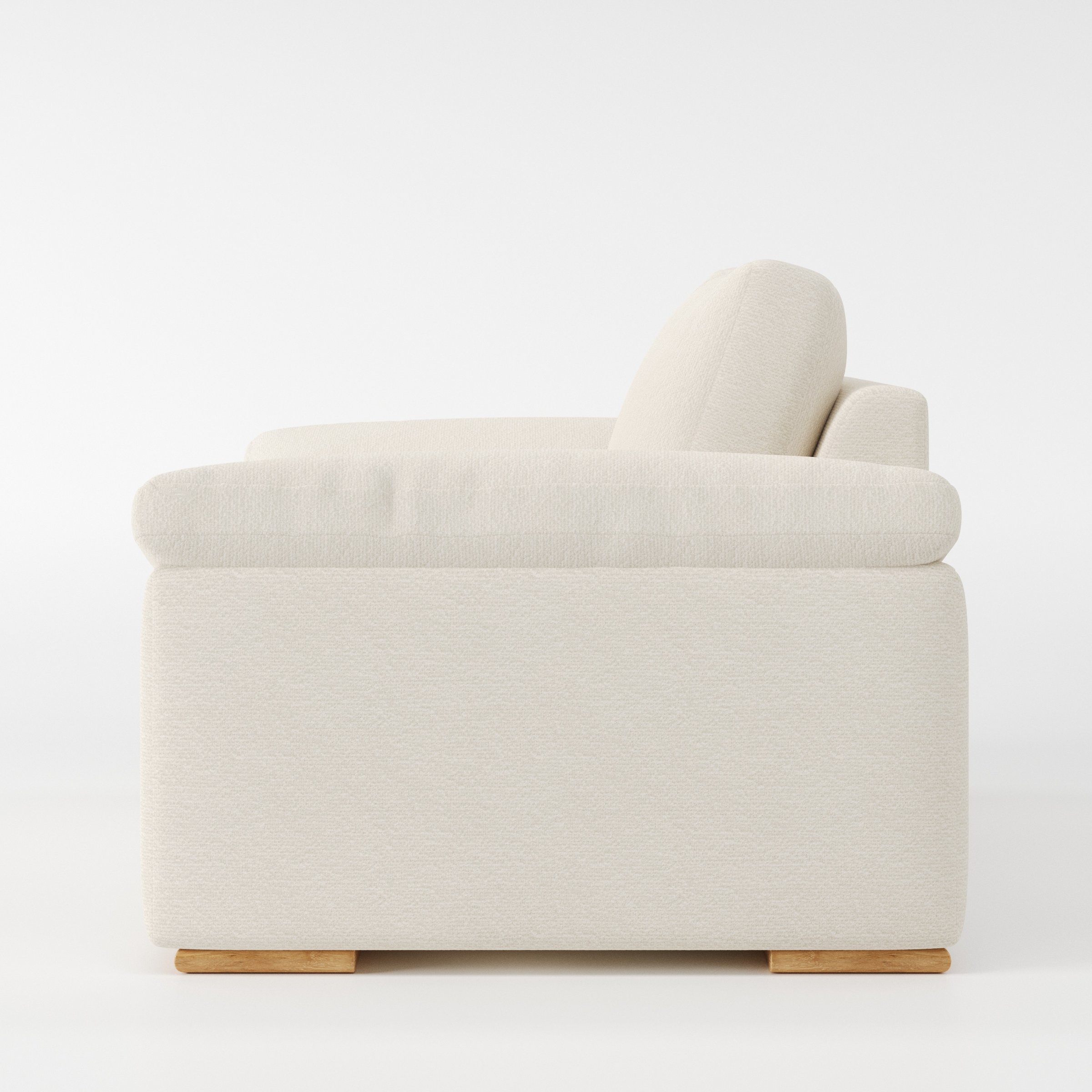Moy armchair in Kilda Boucle Cream shown in side profile displaying proportions and overall silhouette.