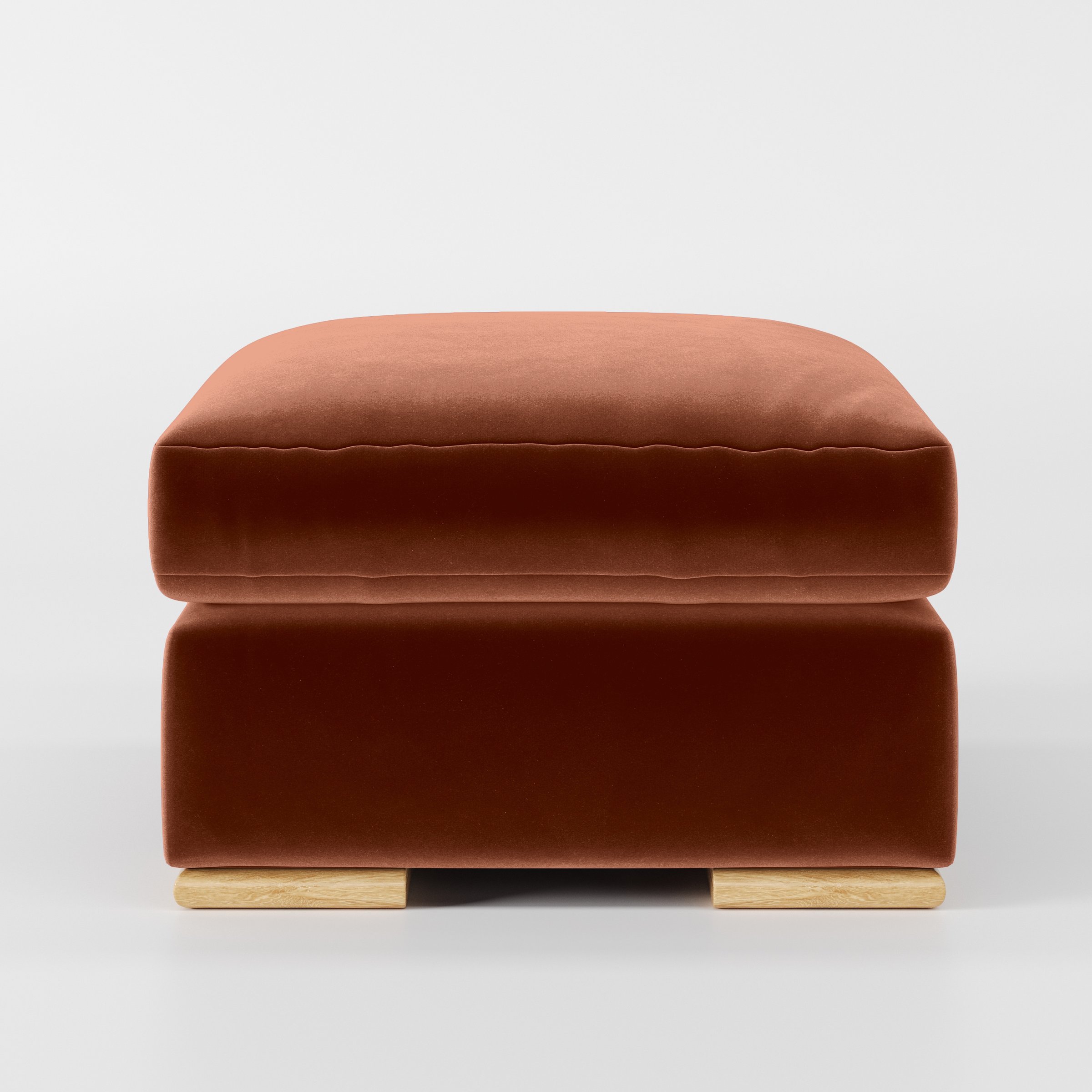 Front view of the Fane footstool upholstered in Plush EasyClean Velvet in Apricot.