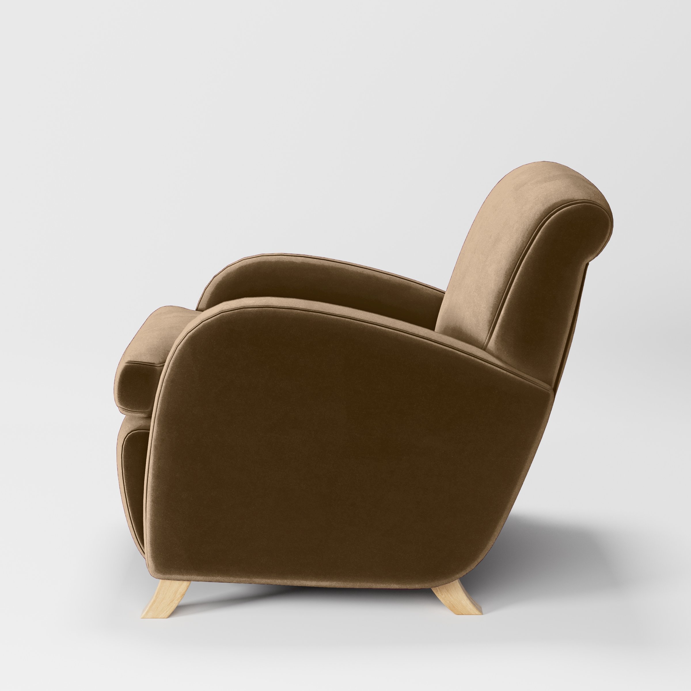 Side view of the Rye armchair upholstered in Plush EasyClean Velvet in Caribou.