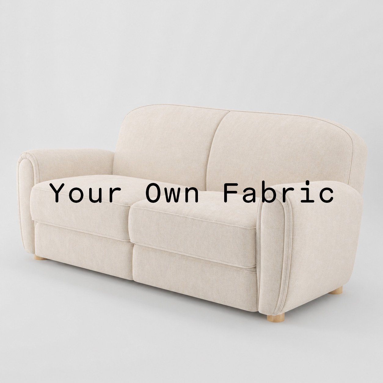 Diagonal view of the Fergus sofa upholstered in customers own material calico cotton fabric.