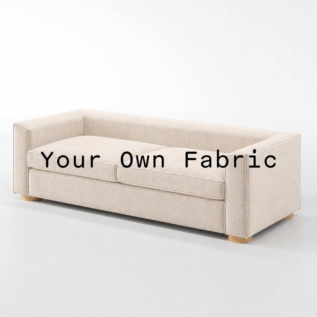 Diagonal view of the Feale sofa upholstered in customers own material calico cotton fabric.