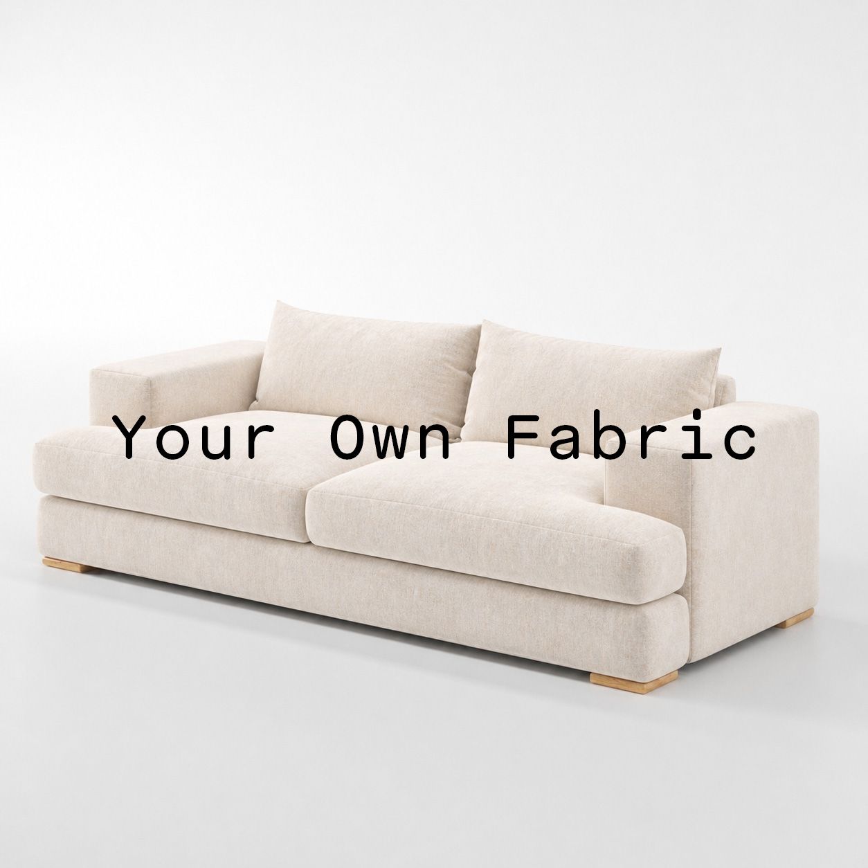 Diagonal view of the Fane sofa upholstered in customers own material calico cotton fabric.