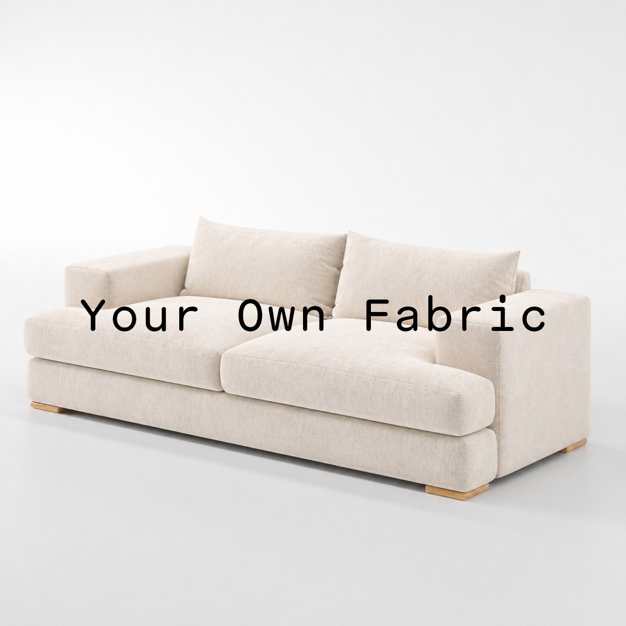 Diagonal view of the Fane sofa upholstered in customers own material calico cotton fabric.