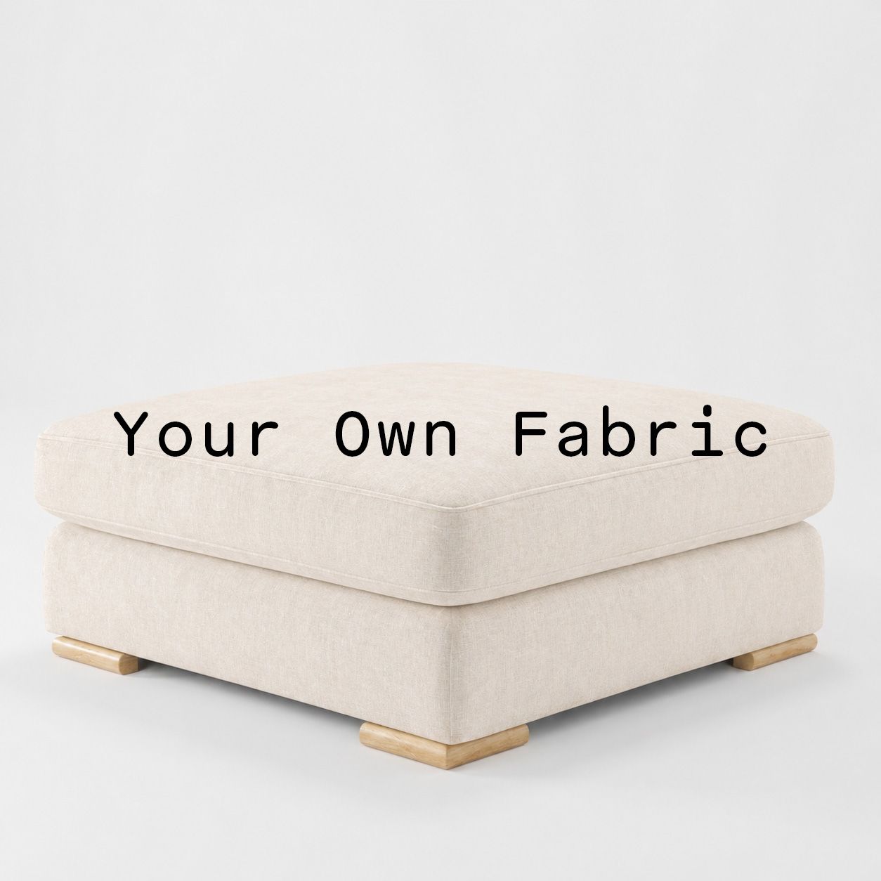 Diagonal view of the Olton footstool upholstered in customers own material calico cotton fabric.