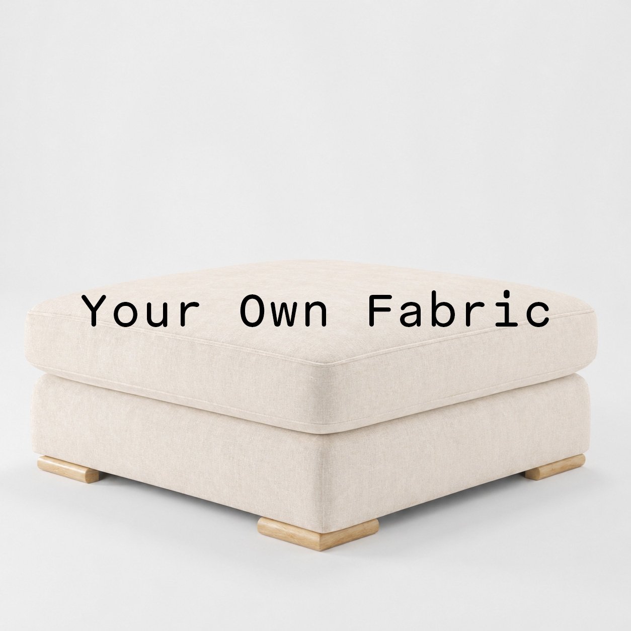 Diagonal view of the Olton footstool upholstered in customers own material calico cotton fabric.