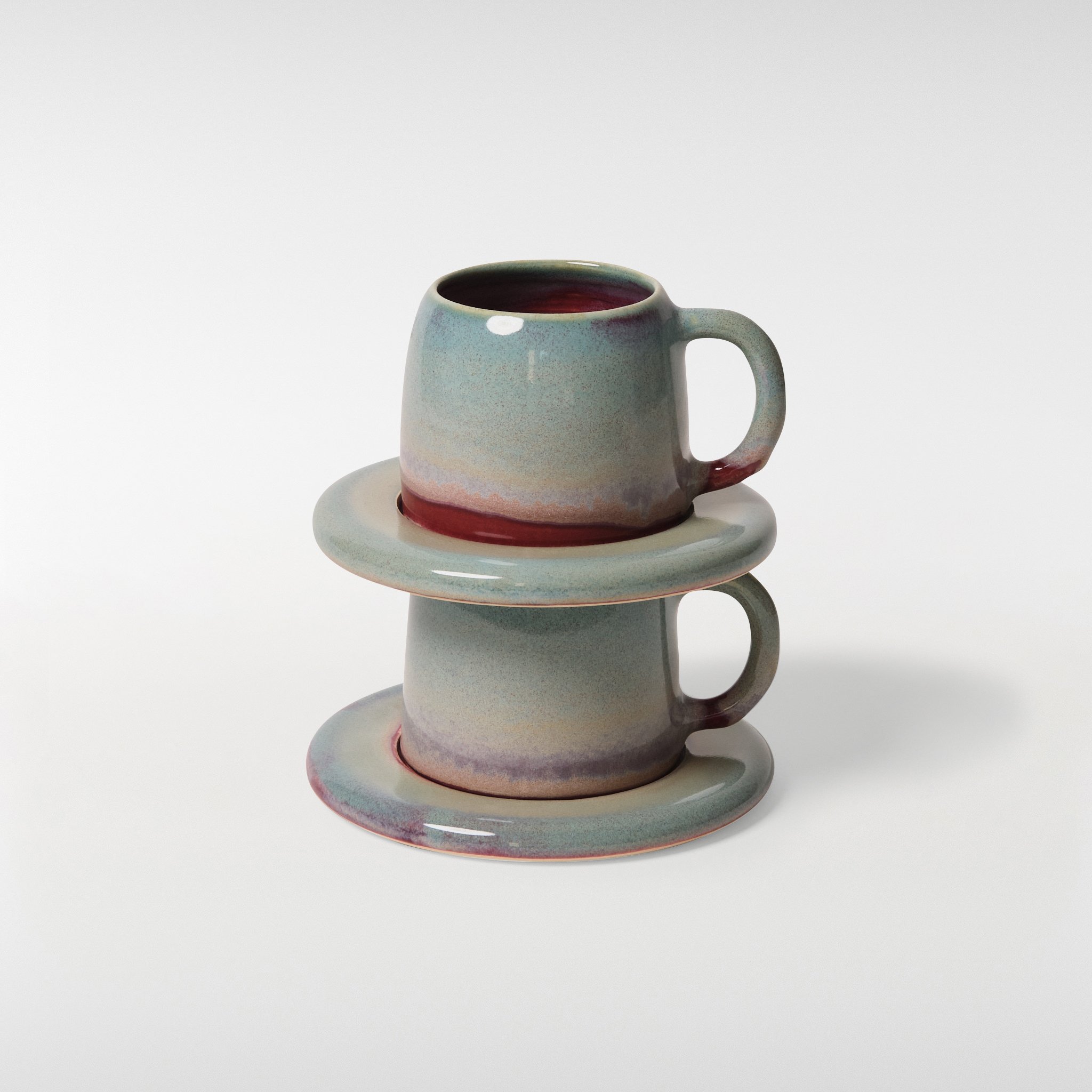 Two loam glazed ceramic cup and saucer sets stacked, showcasing rounded forms, stackable design and fluid glaze finish