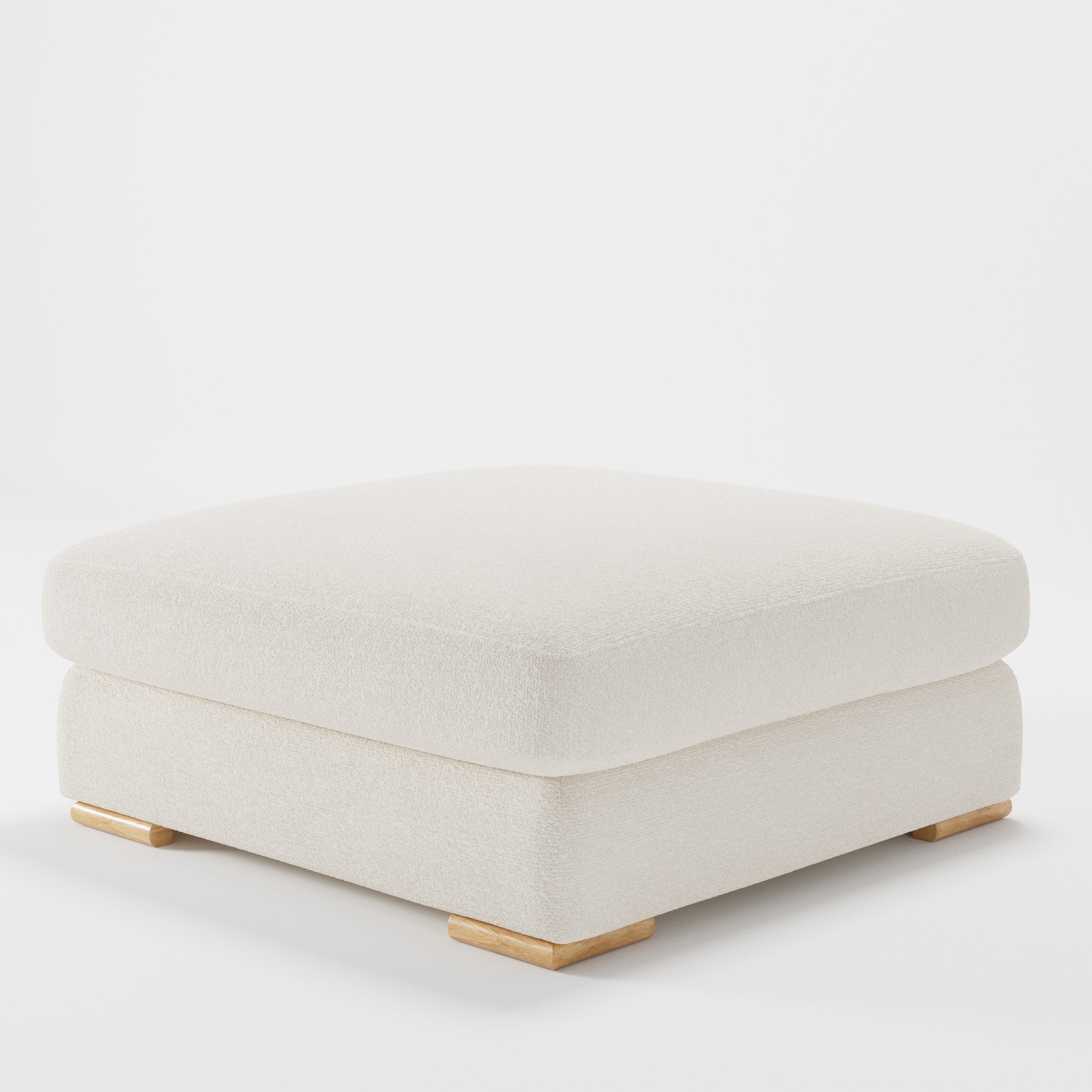 Olton footstool in Kilda Boucle Cream shown at a diagonal angle highlighting low profile and inset wooden base.