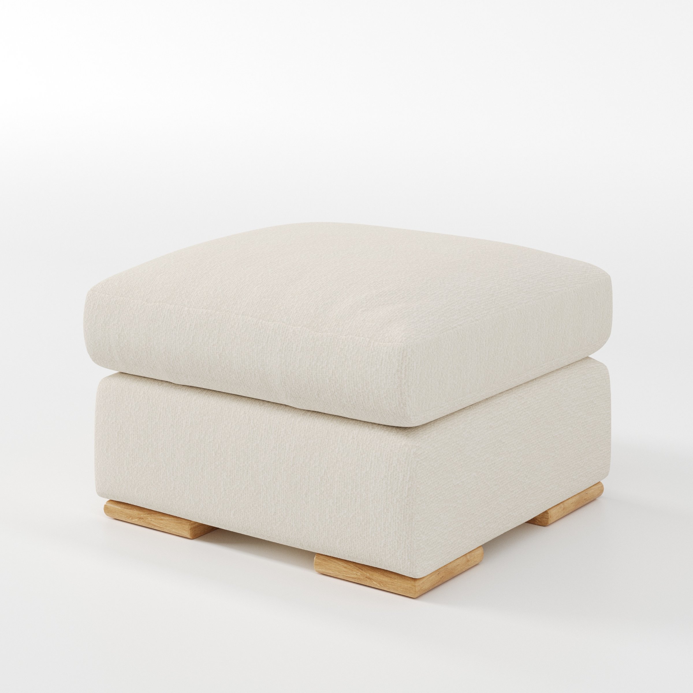 Moy footstool in Kilda Boucle Cream shown at a diagonal angle highlighting deep cushioning and low wooden base.