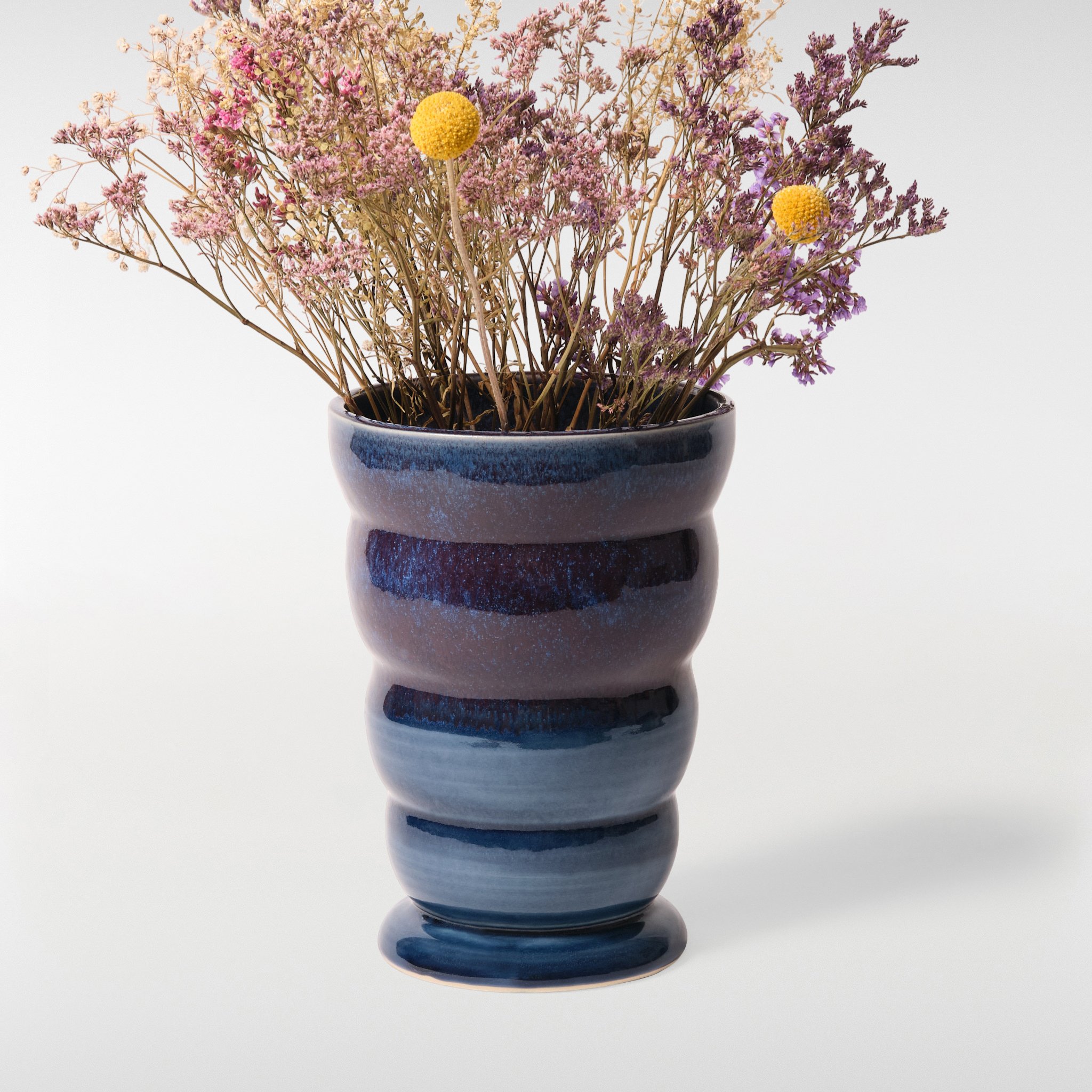 Loam Vase 2 in blue tonal glaze with dried flowers, sculptural ceramic vase with curved stacked form