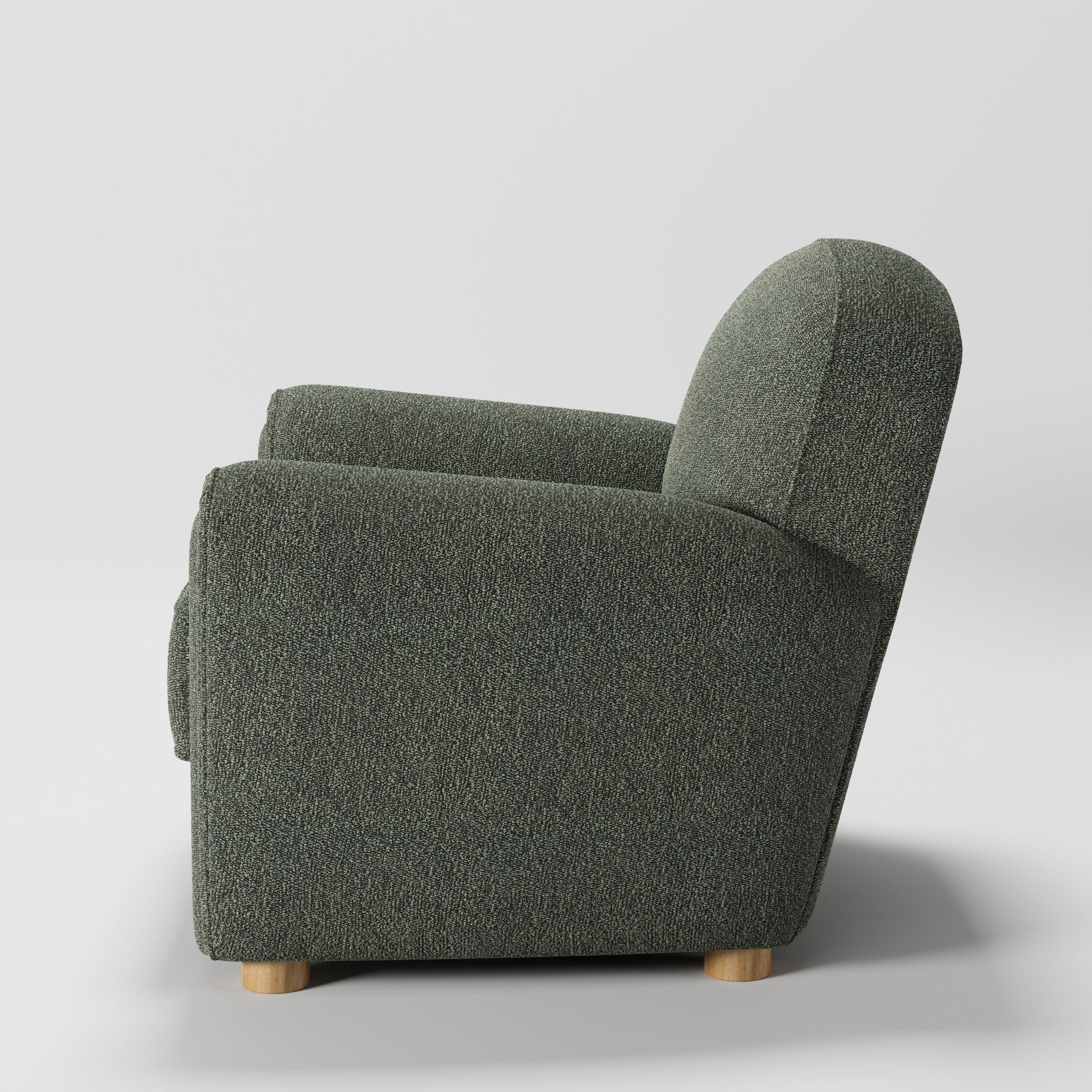 Fergus armchair in Kilda Boucle Moss shown in side profile displaying proportions and overall silhouette.