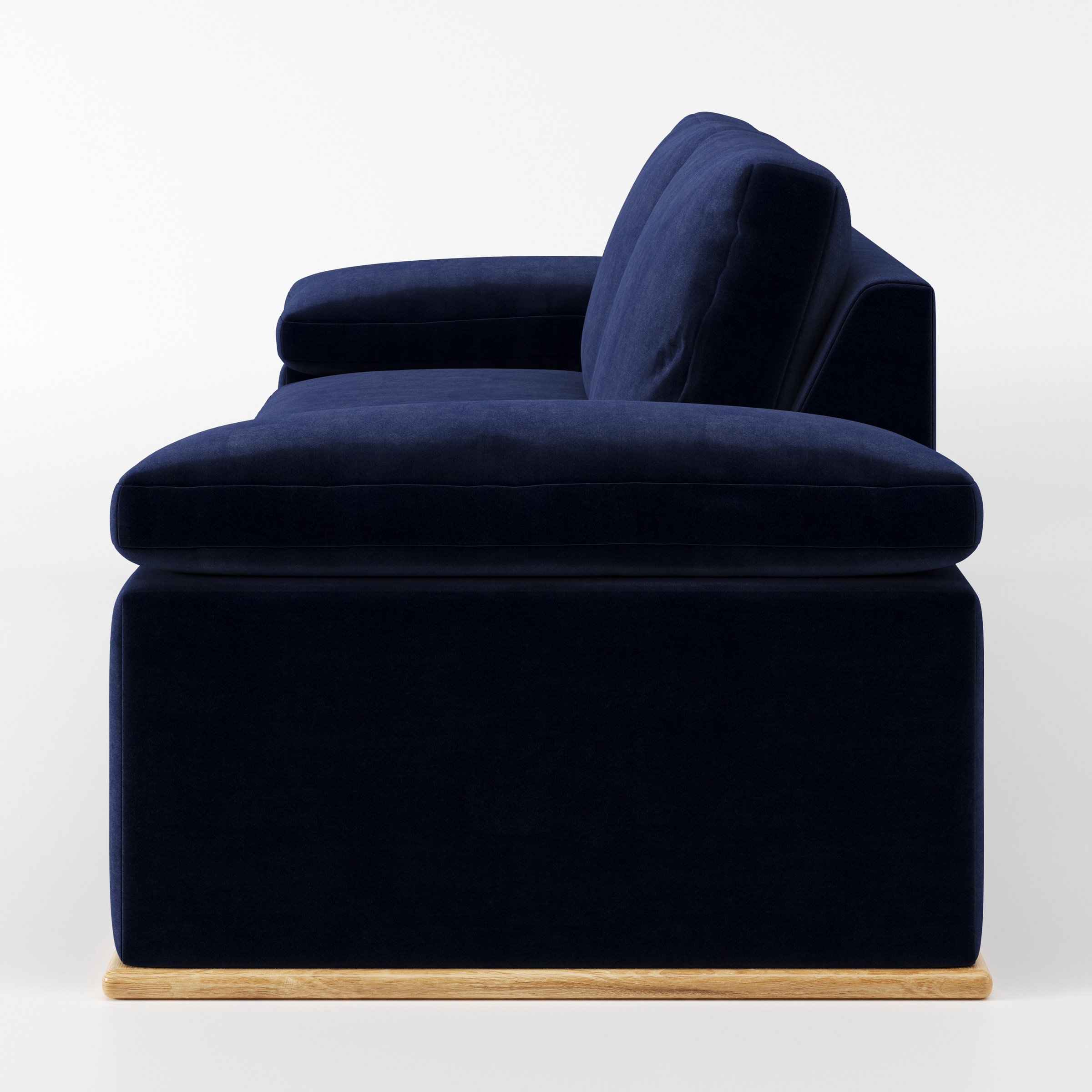 Cusher sofa in Noss Velvet Navy shown in side profile displaying proportions and overall silhouette.