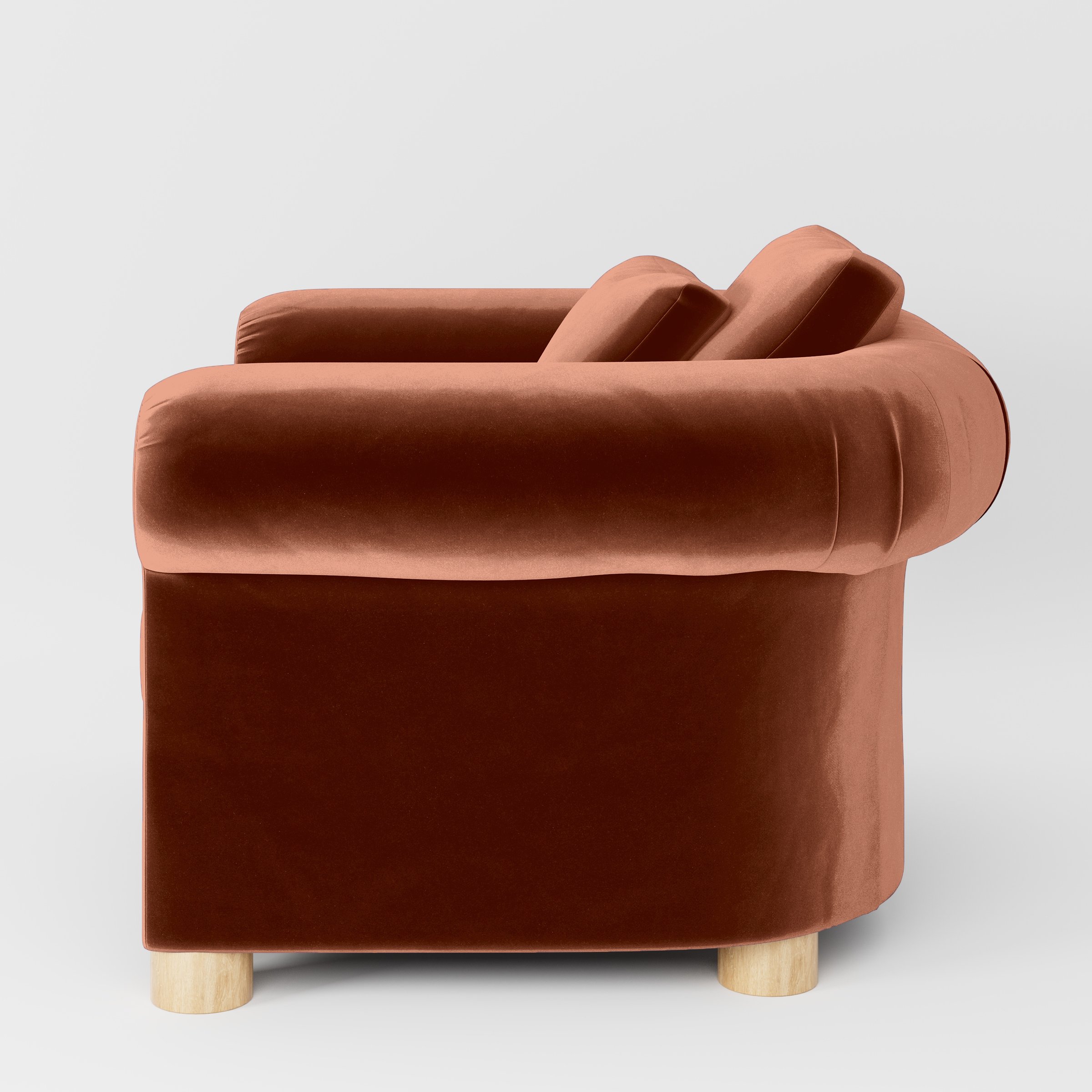 Side view of the Windermere armchair upholstered in Plush EasyClean Velvet in Apricot.