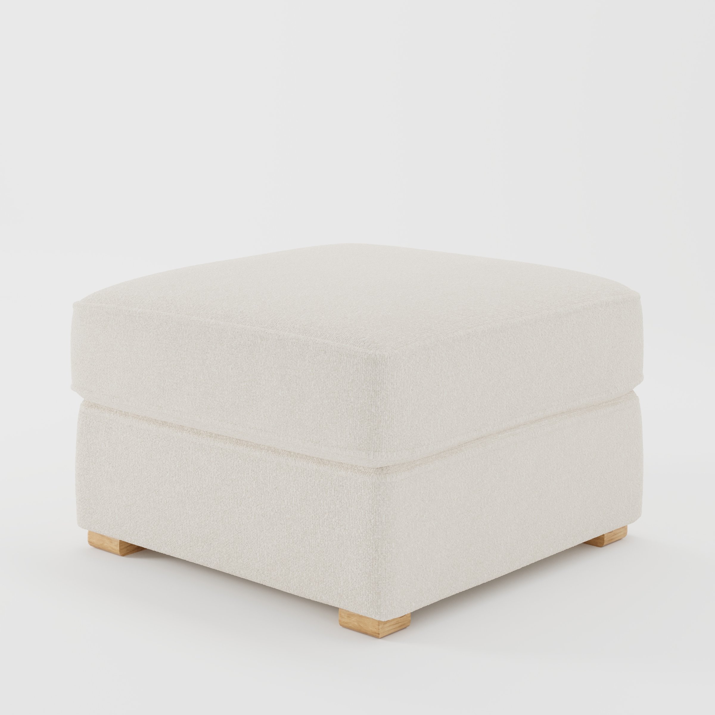 Cashel footstool in Kilda Boucle Cream shown at a diagonal angle highlighting layered cushioning and low wooden feet.