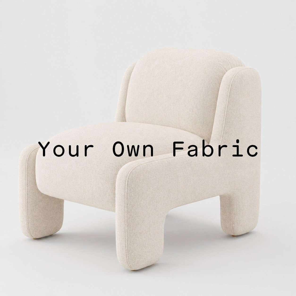 Diagonal view of the Inny armchair upholstered in customers own material calico cotton fabric.