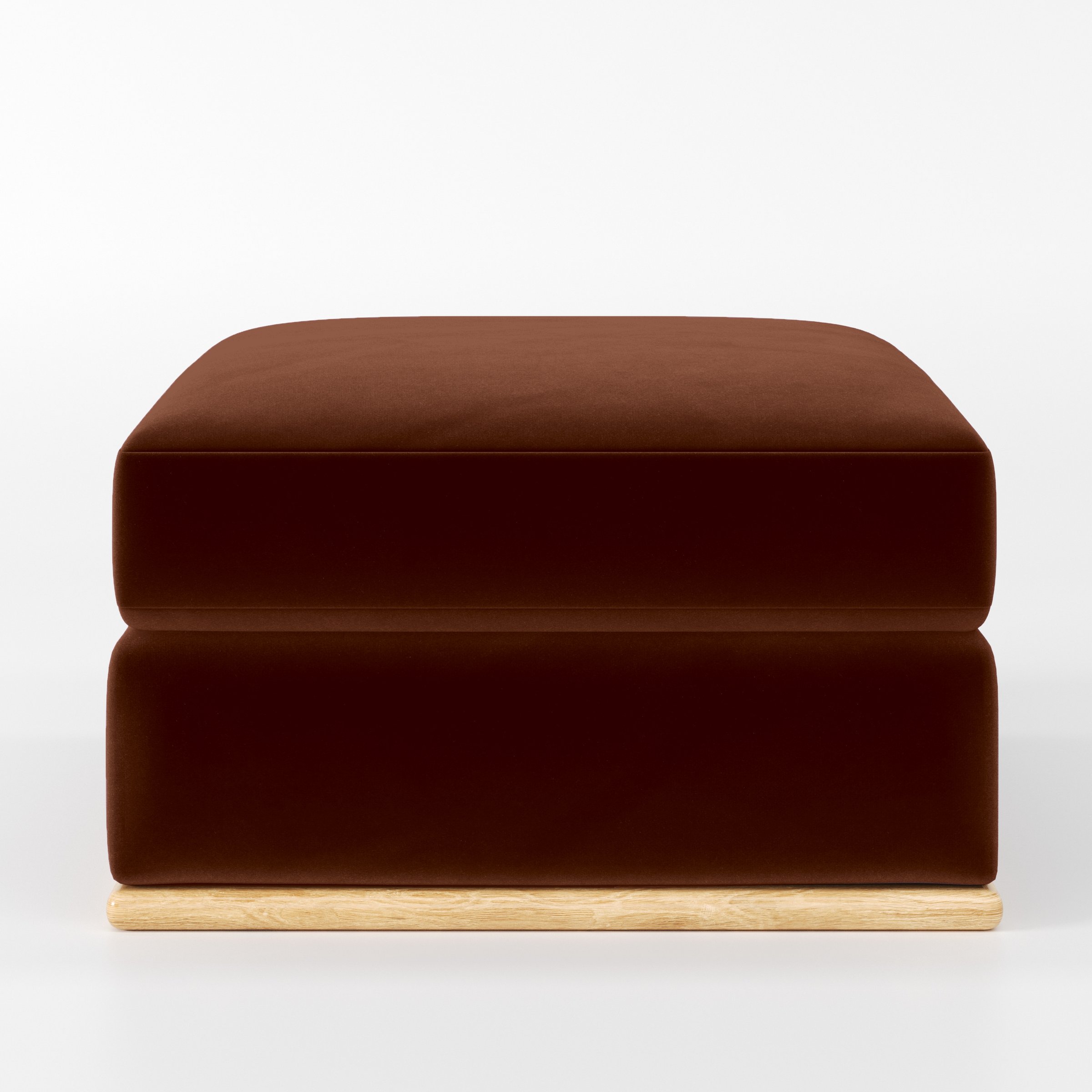 Front view of the Cusher footstool upholstered in Plush EasyClean Velvet in Maple.