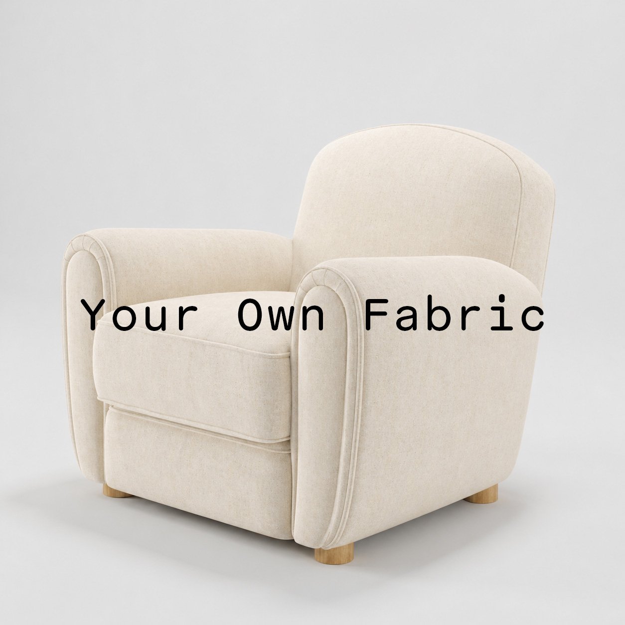 Diagonal view of the Fergus armchair upholstered in customers own material calico cotton fabric.