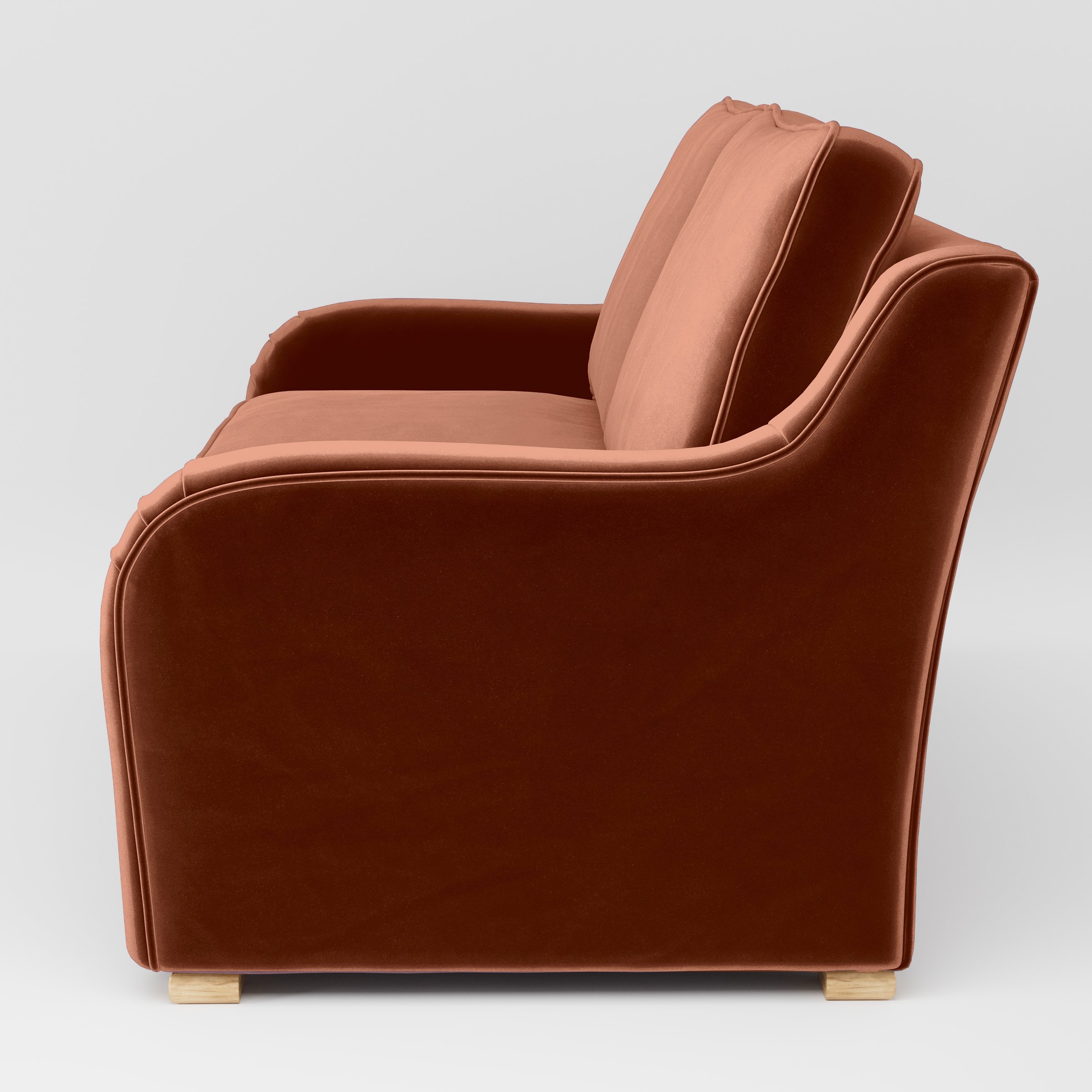 Side view of the Cashel sofa upholstered in Plush EasyClean Velvet in Apricot.