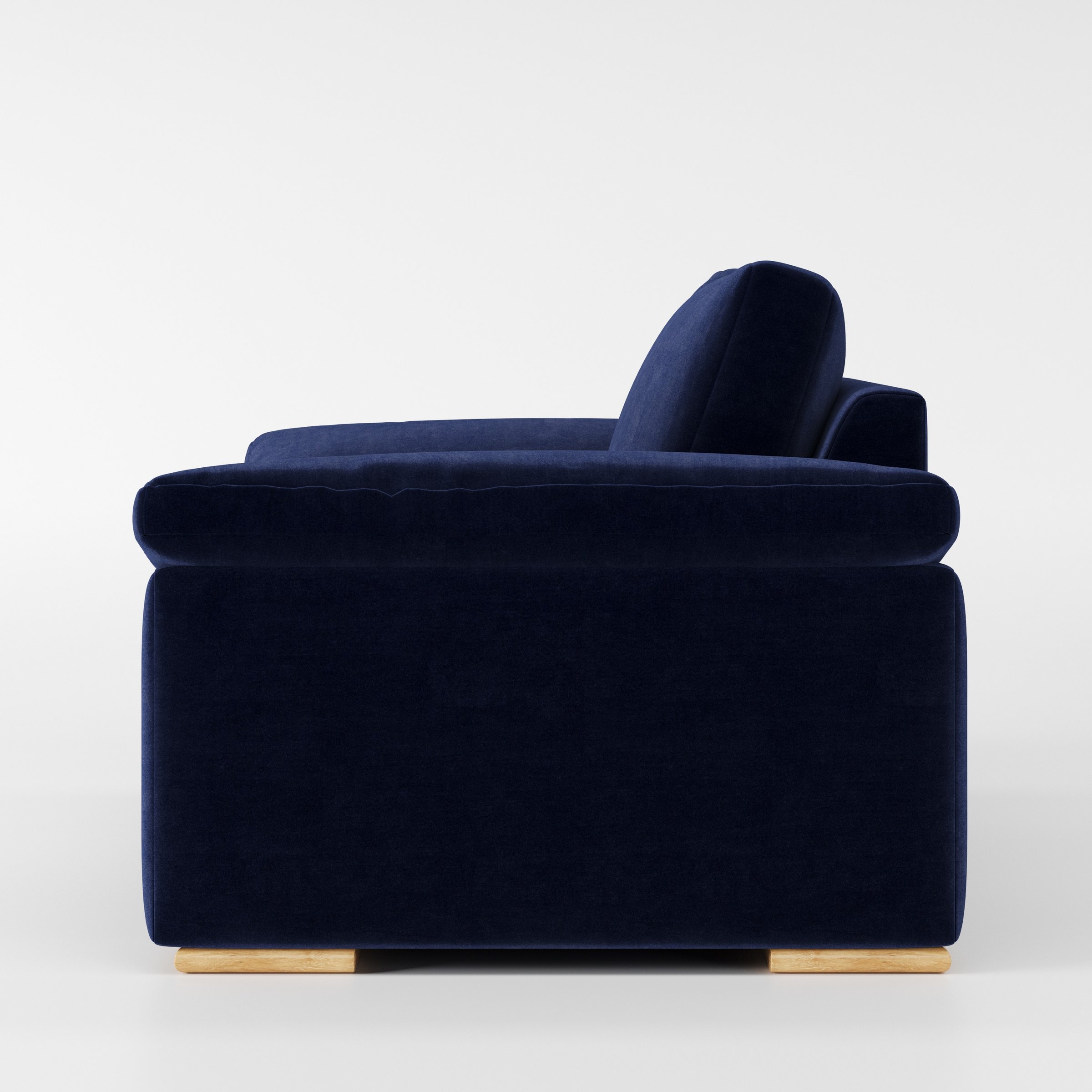 Moy armchair in Noss Velvet Navy shown in side profile displaying proportions and overall silhouette.