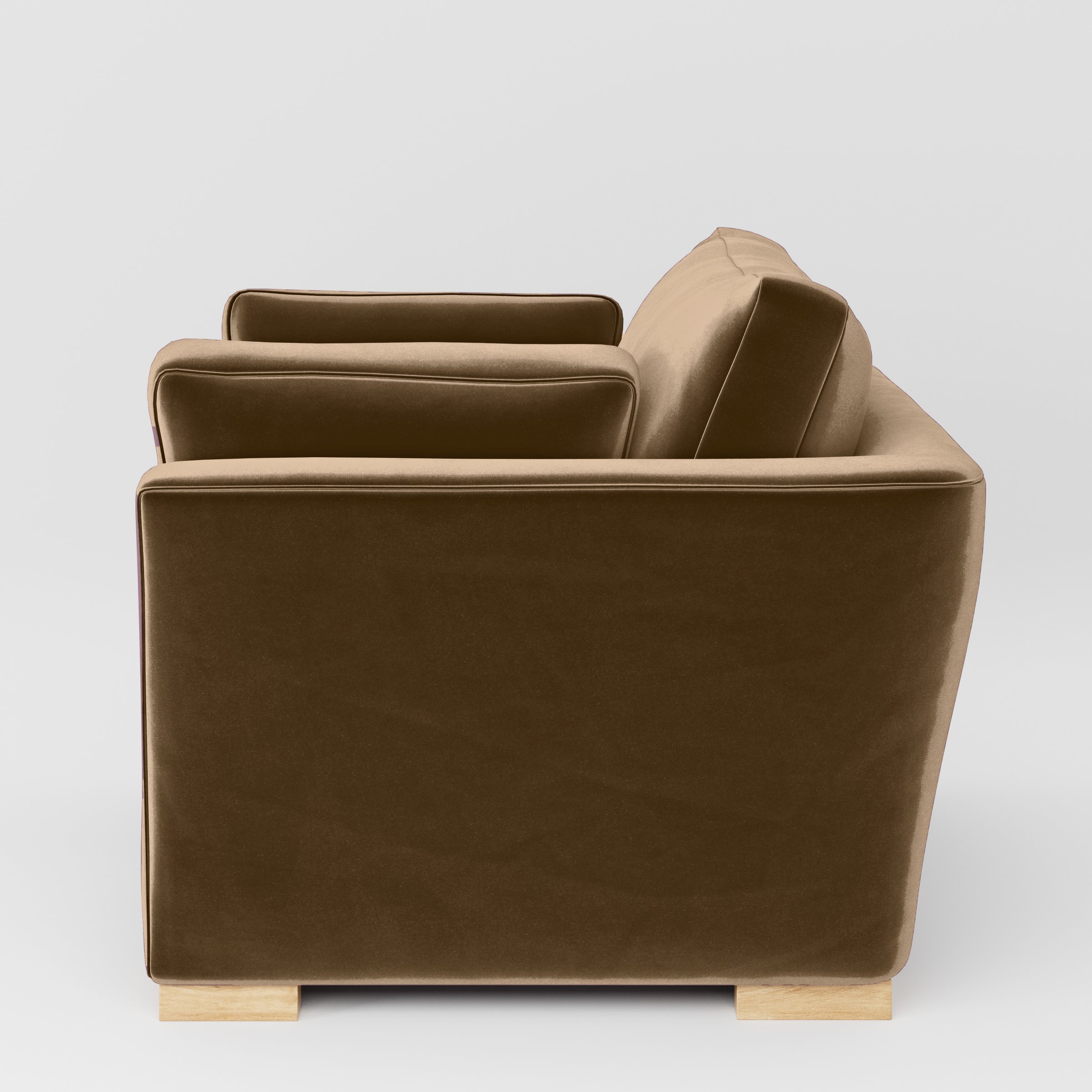 Side view of the Stowe armchair upholstered in Plush EasyClean Velvet in Caribou.