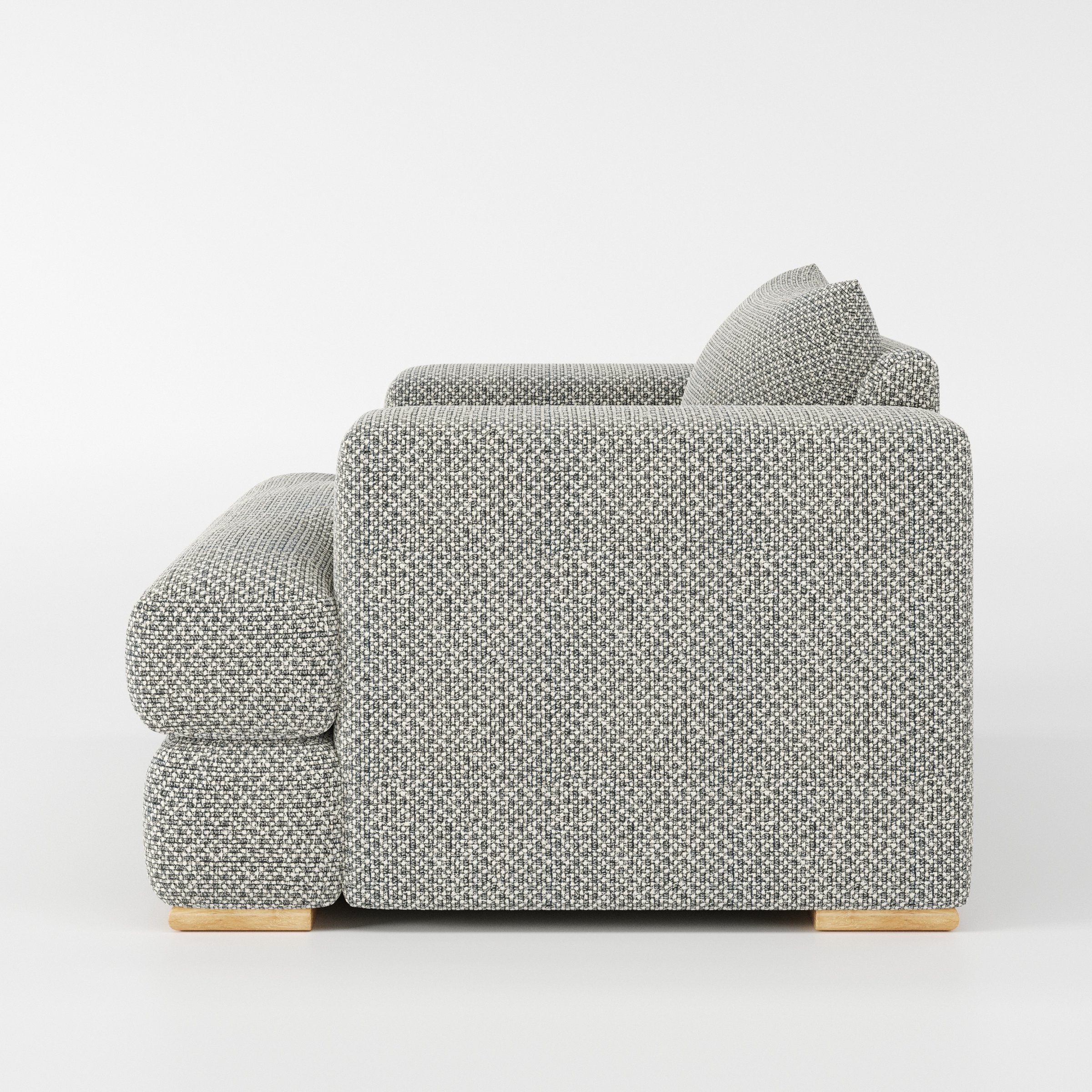 Fane armchair in Rousay Wool Blend Tar and Chalk shown in side profile displaying proportions and overall silhouette.