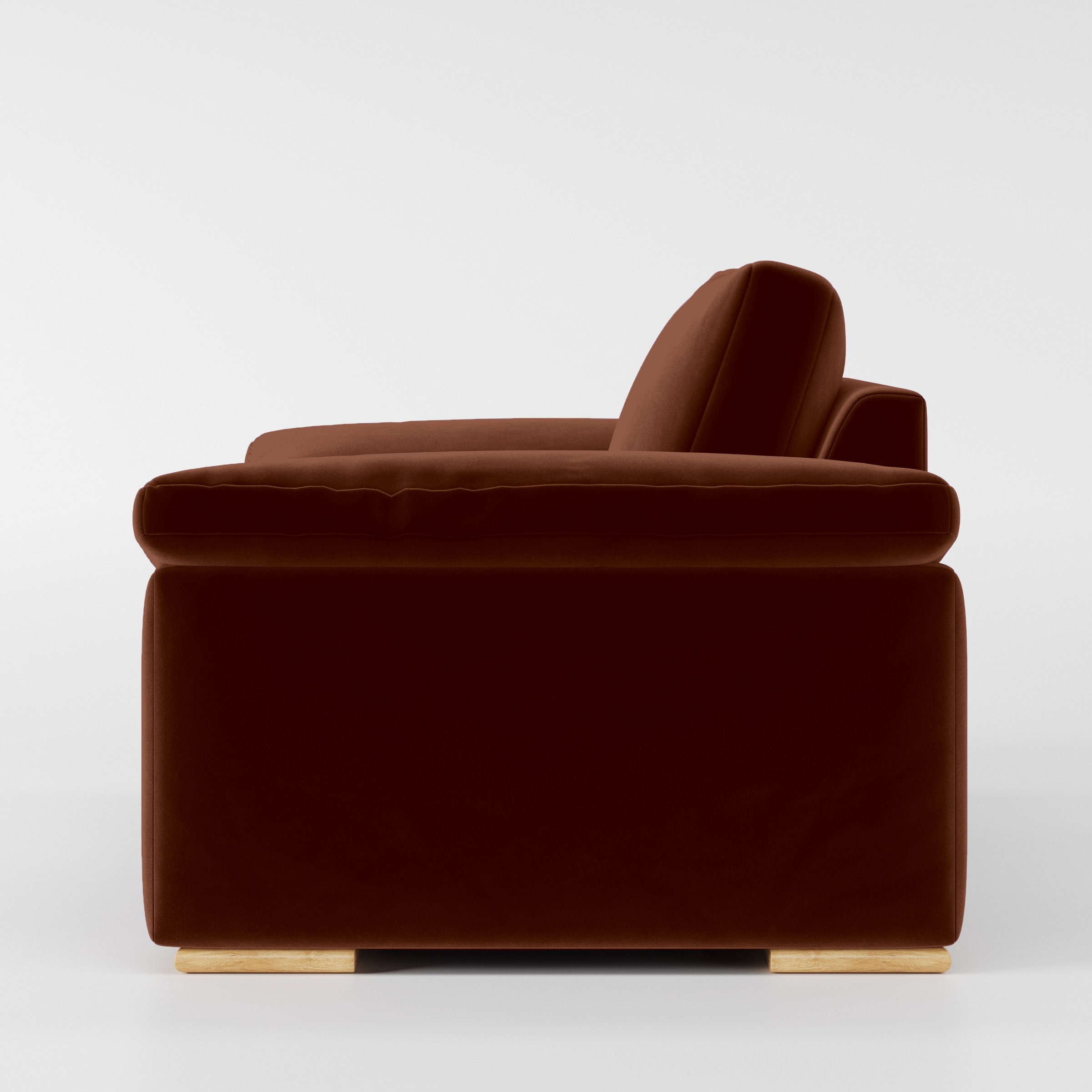 Side view of the Moy armchair upholstered in Plush EasyClean Velvet in Maple.