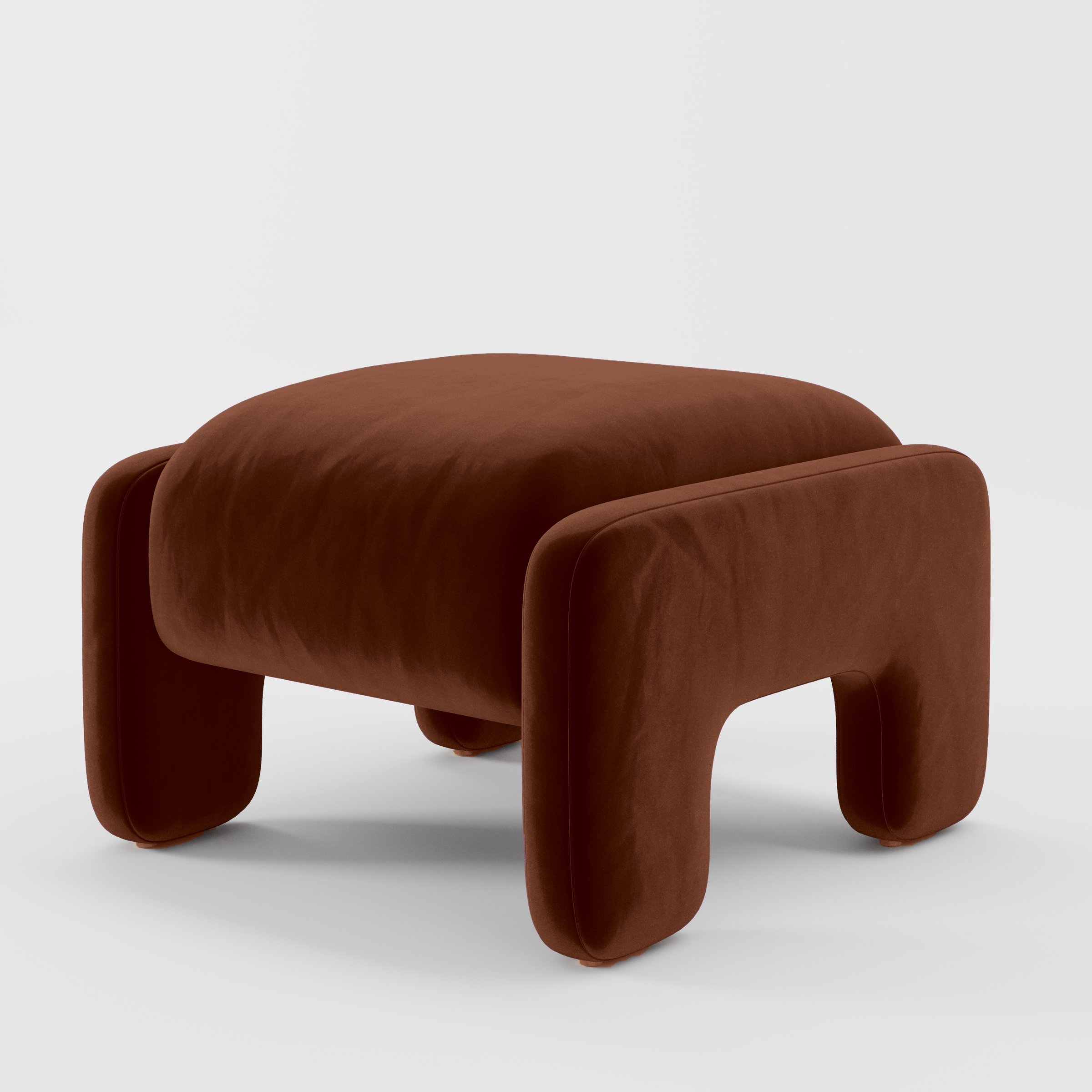 Diagonal view of the Inny footstool upholstered in Plush EasyClean Velvet in Maple.