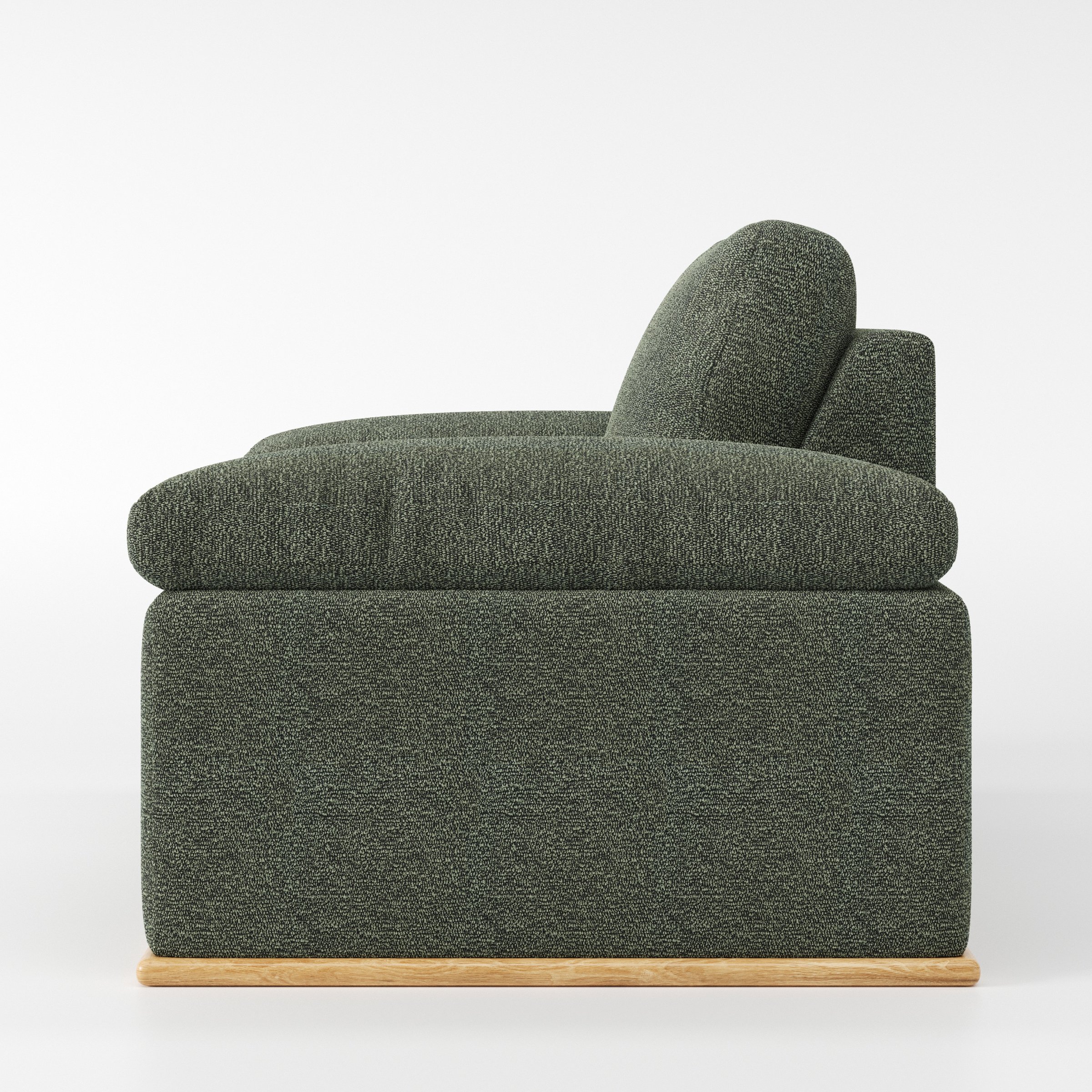 Cusher armchair in Kilda Boucle Moss shown in side profile displaying proportions and overall silhouette.
