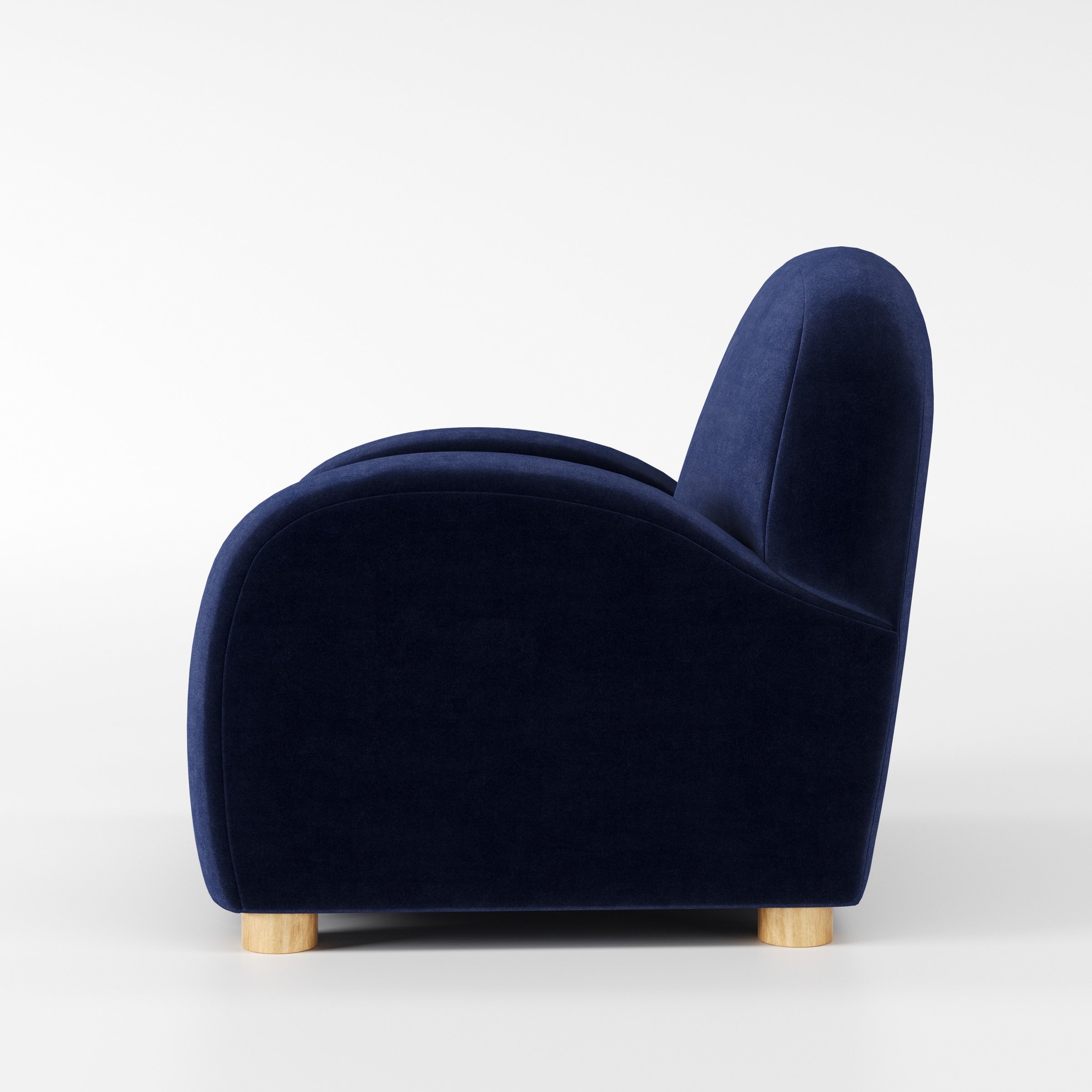 Awe armchair in Noss Velvet Navy shown in side profile displaying proportions and overall silhouette.