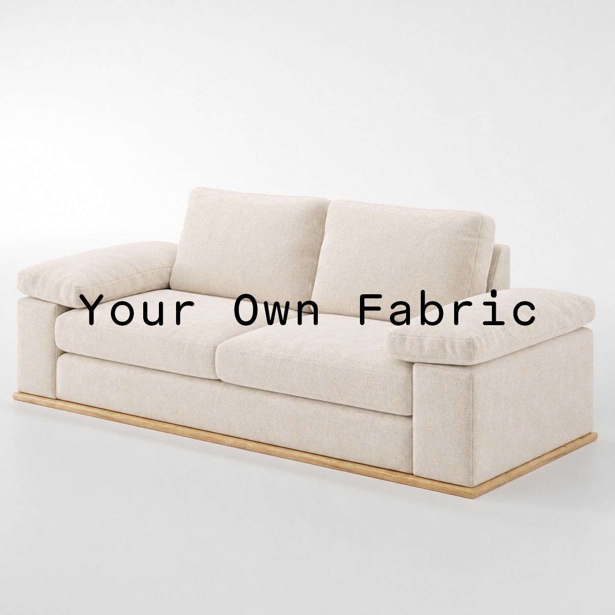 Diagonal view of the Cusher sofa upholstered in customers own material calico cotton fabric.