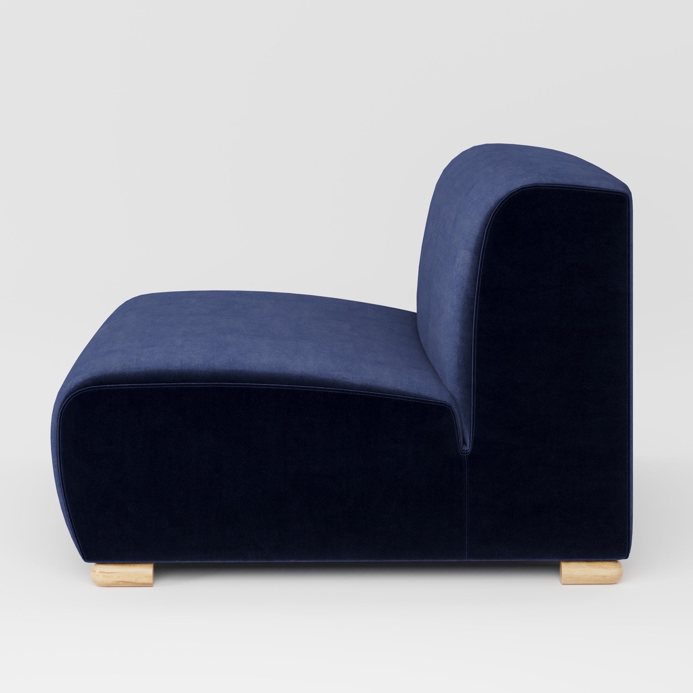 Tay single sofa unit in Noss Velvet Navy shown from the side showing the low backrest, deep seat and timber feet.