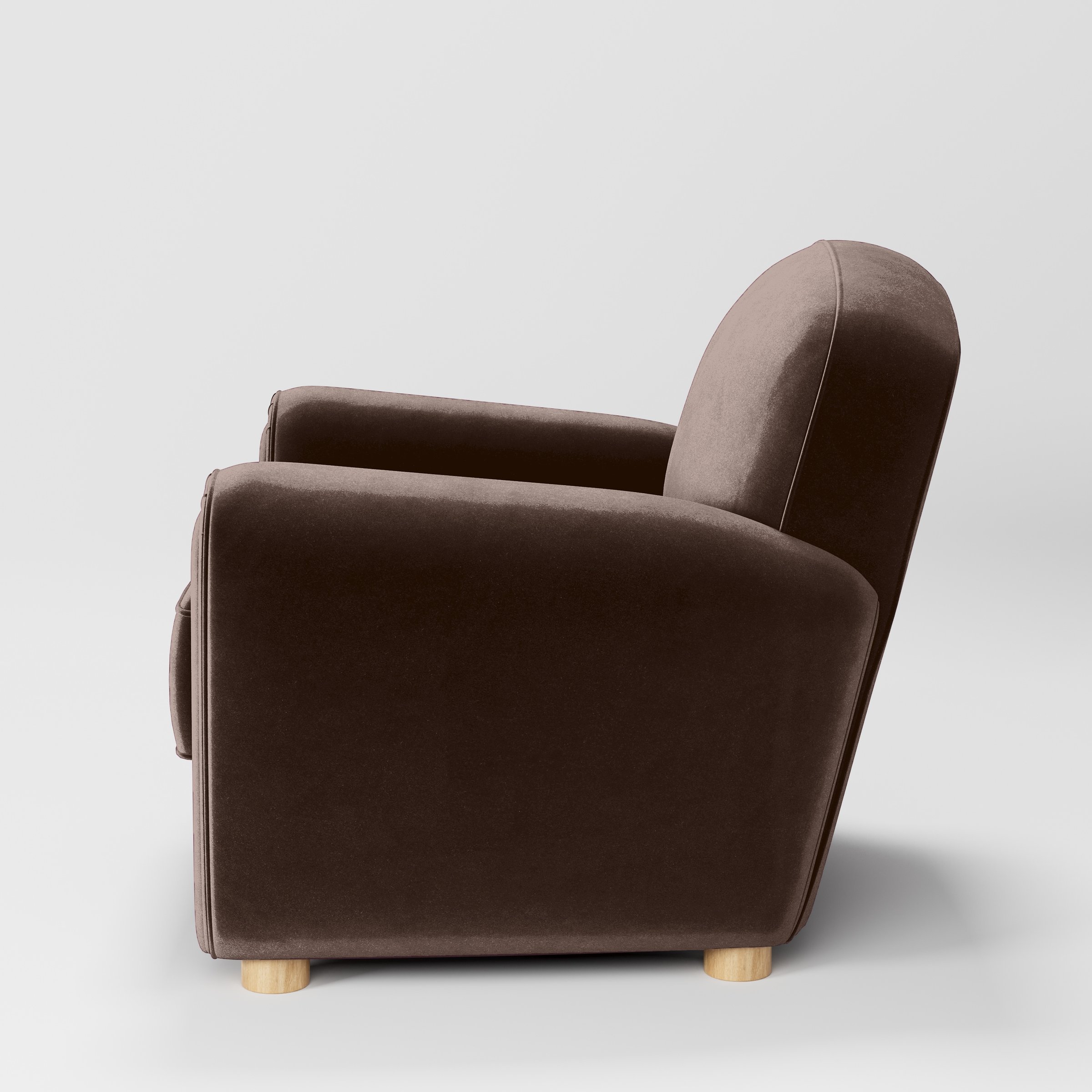 Side view of the Fergus armchair upholstered in Plush EasyClean Velvet in Mole.