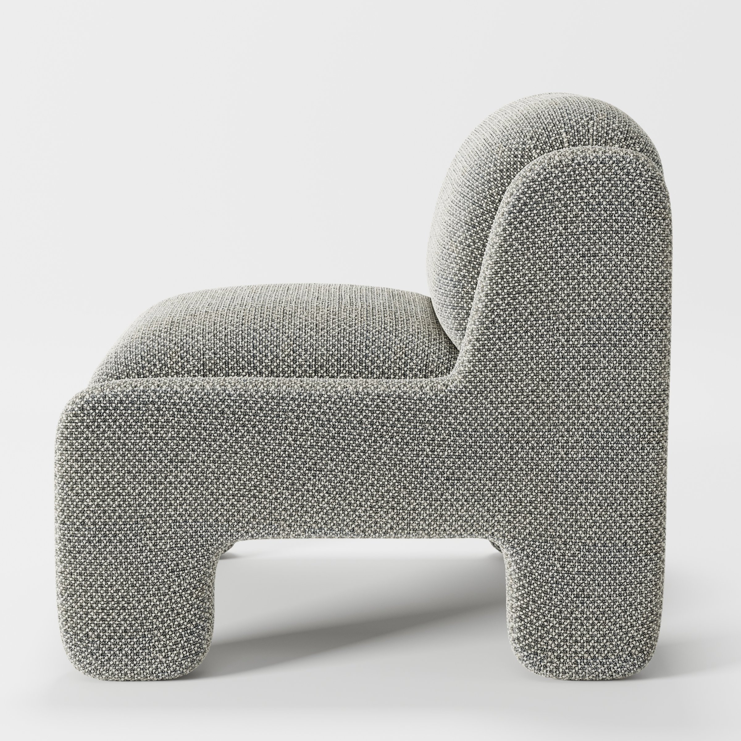 Inny armchair in Rousay Wool Blend Tar and Chalk shown in side profile displaying proportions and overall silhouette.