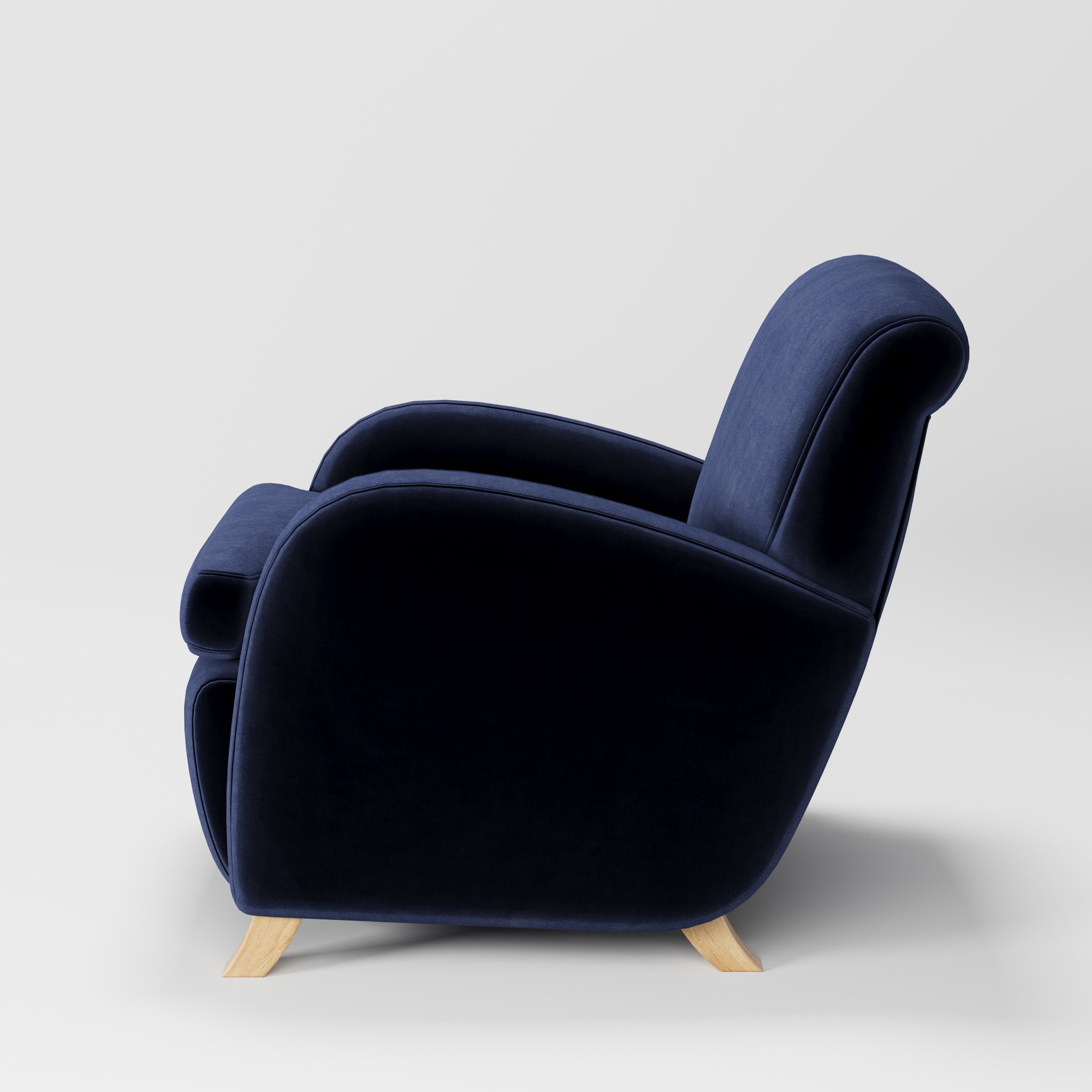 Rye armchair in Noss Velvet Navy shown in side profile displaying proportions and overall silhouette.