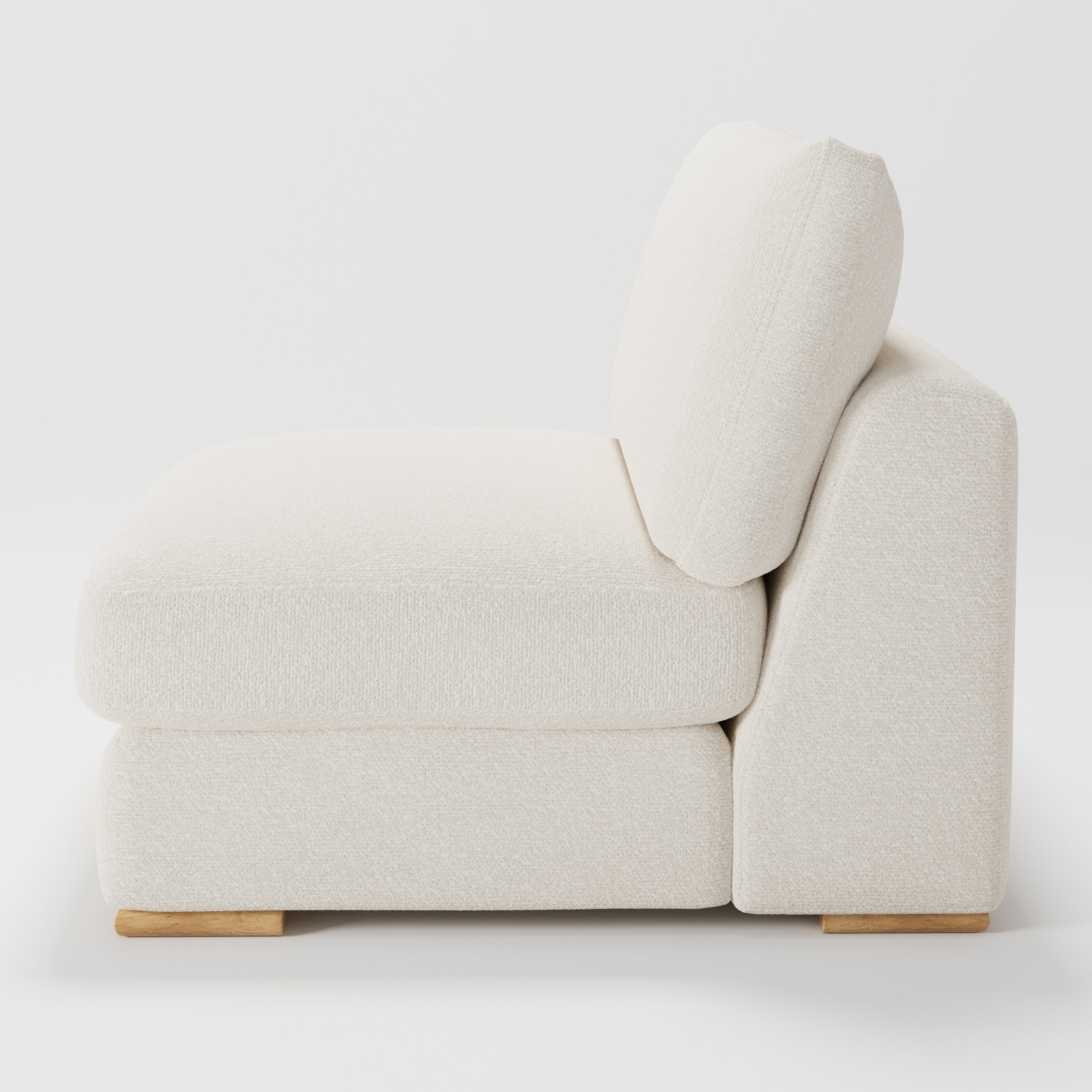 Olton single sofa unit in Kilda Bouclé Cream shown from the side showing the layered seat cushion and angled back cushion with timber feet.