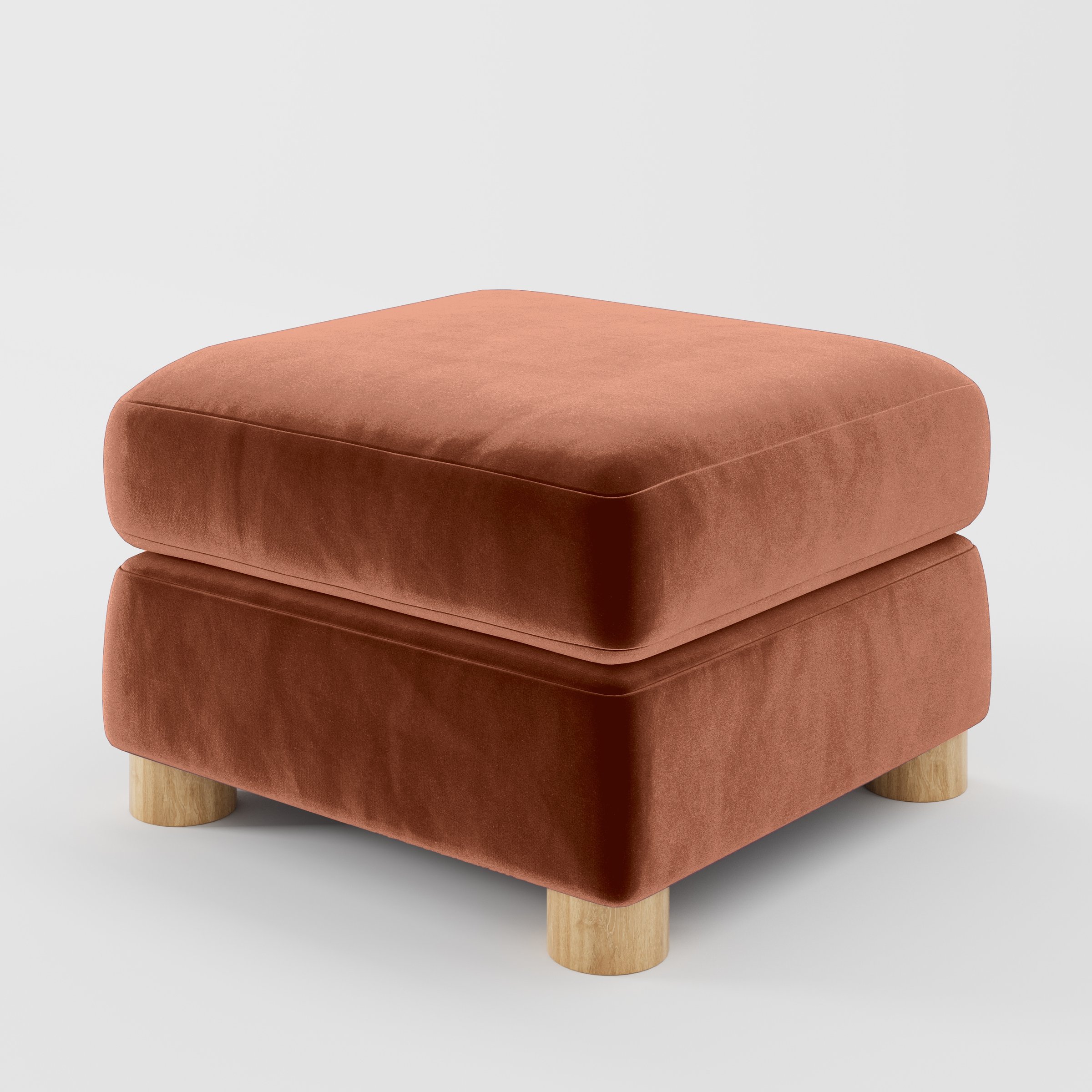 Diagonal view of the Windermere footstool upholstered in Plush EasyClean Velvet in Apricot.