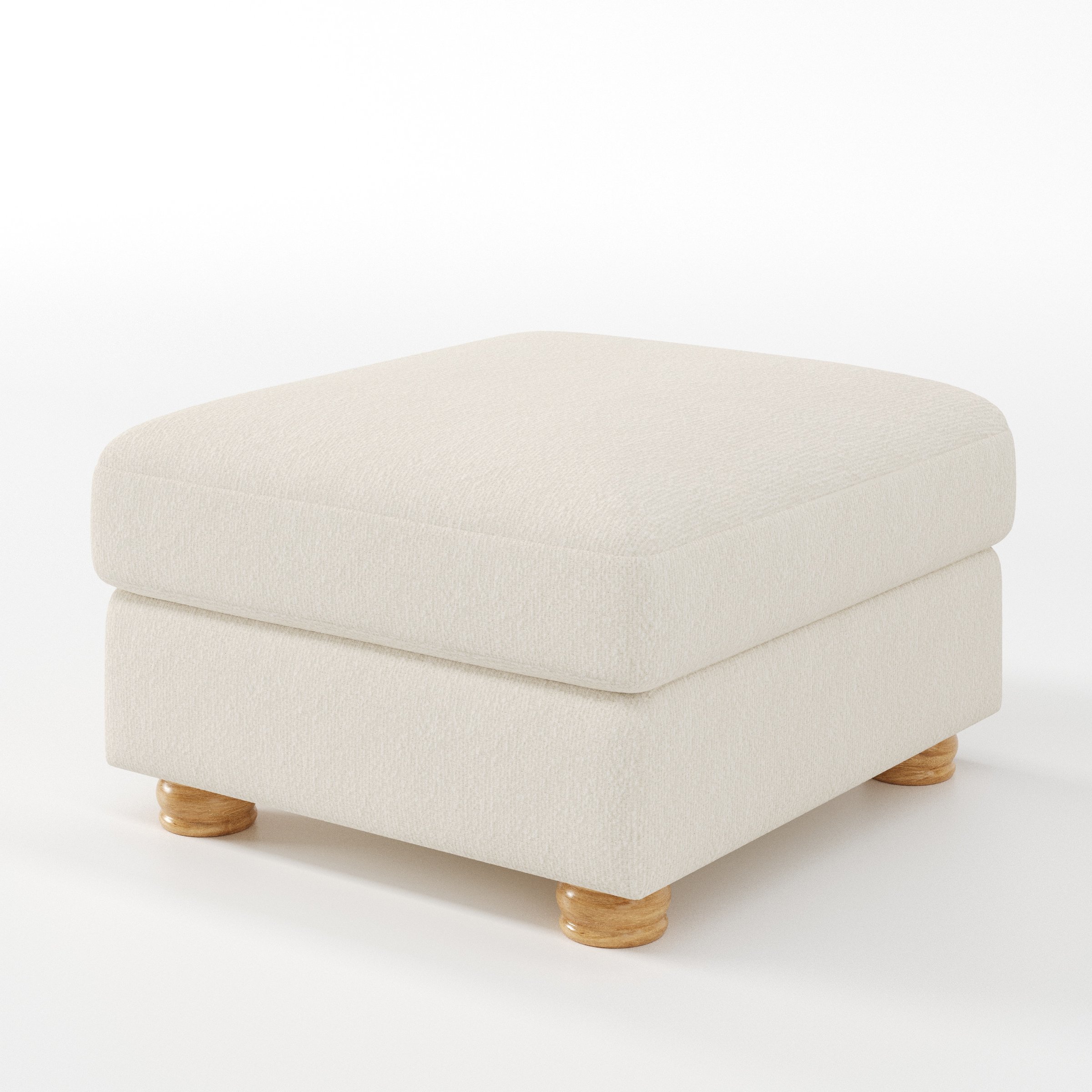 Anna Lee footstool in Kilda Boucle Cream shown at a diagonal angle highlighting soft cushioning and turned wooden feet.