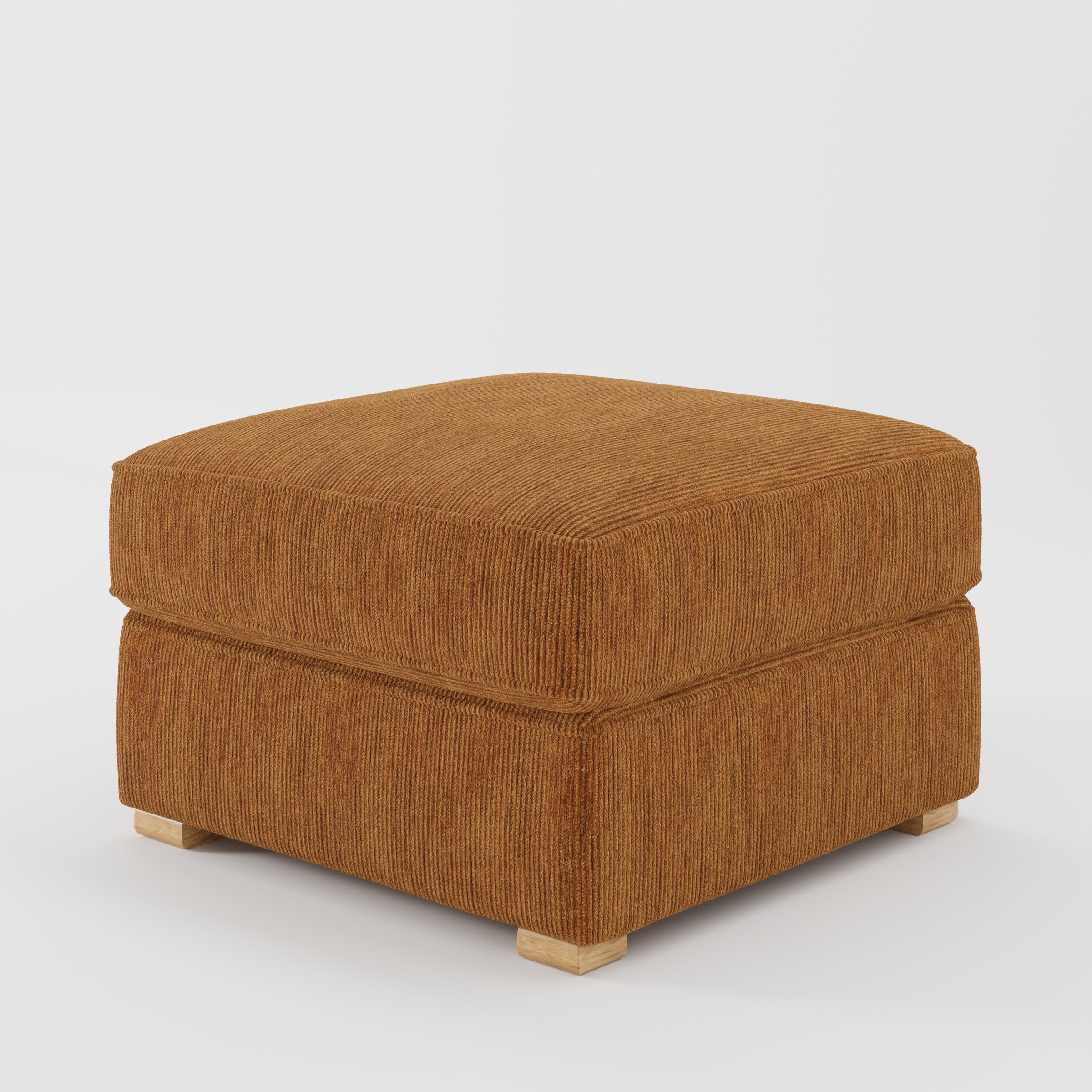 Cashel footstool in Caldey Velvet Corduroy Tobacco shown at a diagonal angle highlighting layered cushioning and low wooden feet.