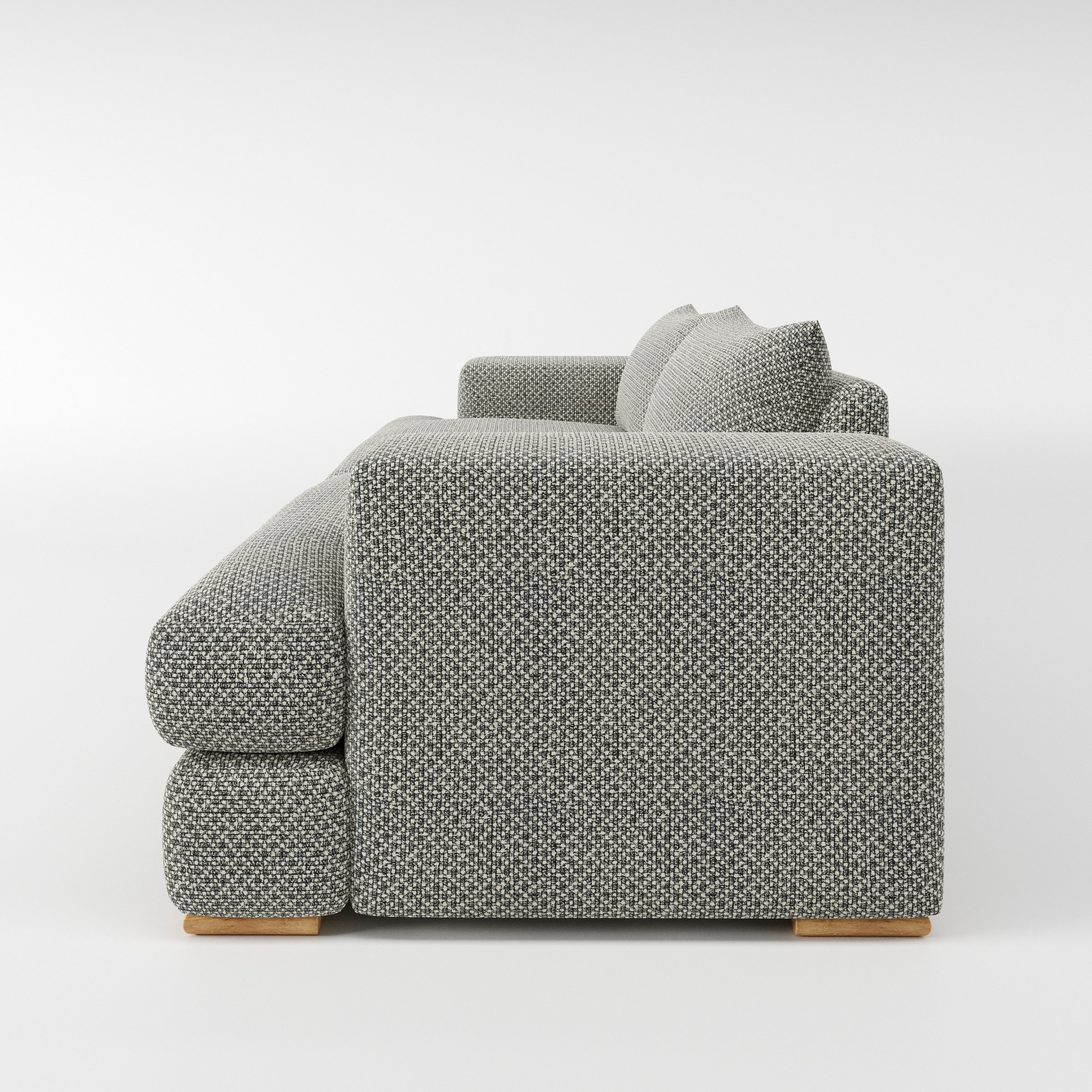 Fane sofa in Rousay Wool Blend Tar and Chalk shown in side profile displaying proportions and overall silhouette.