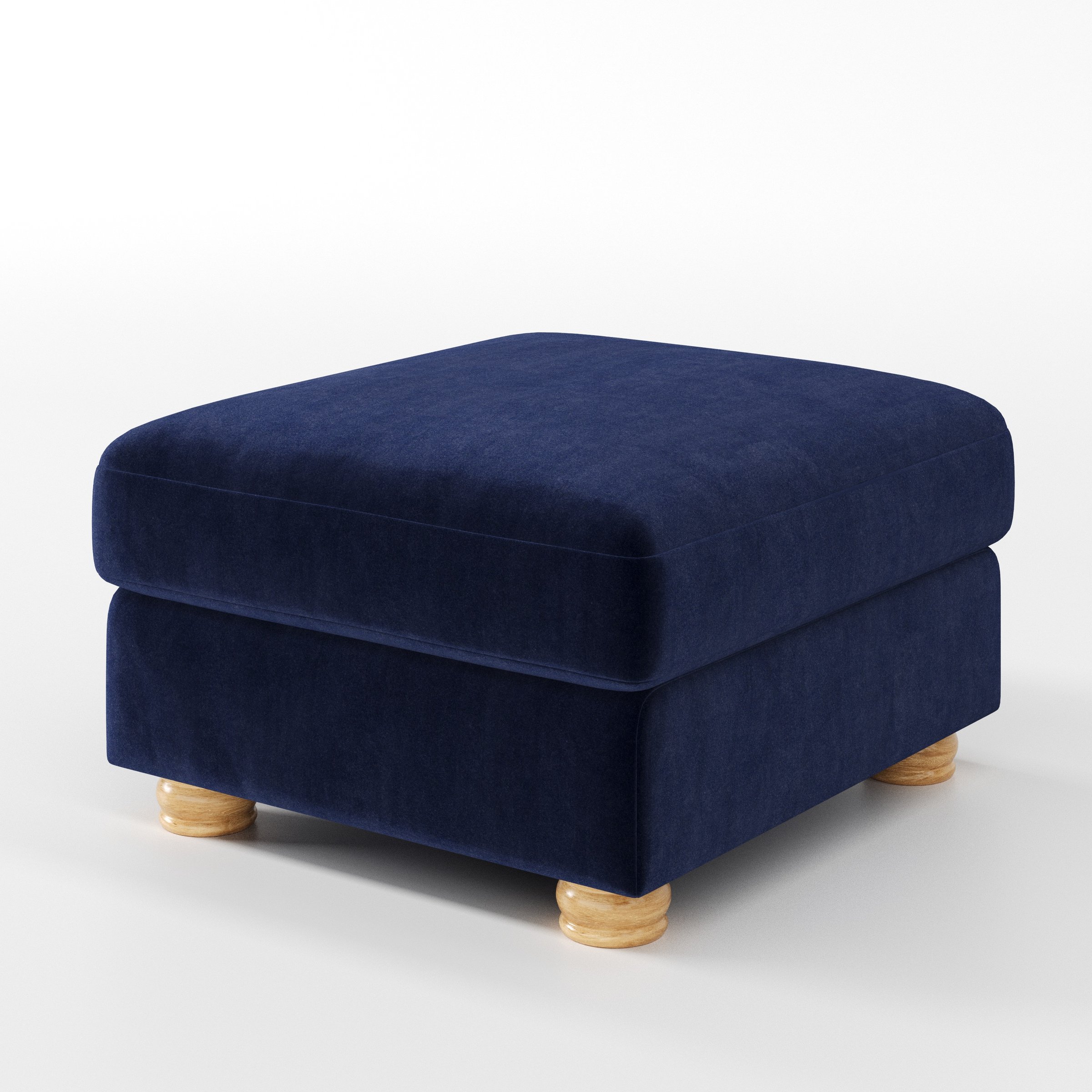 Anna Lee footstool in Noss Velvet Navy shown at a diagonal angle highlighting soft cushioning and turned wooden feet.