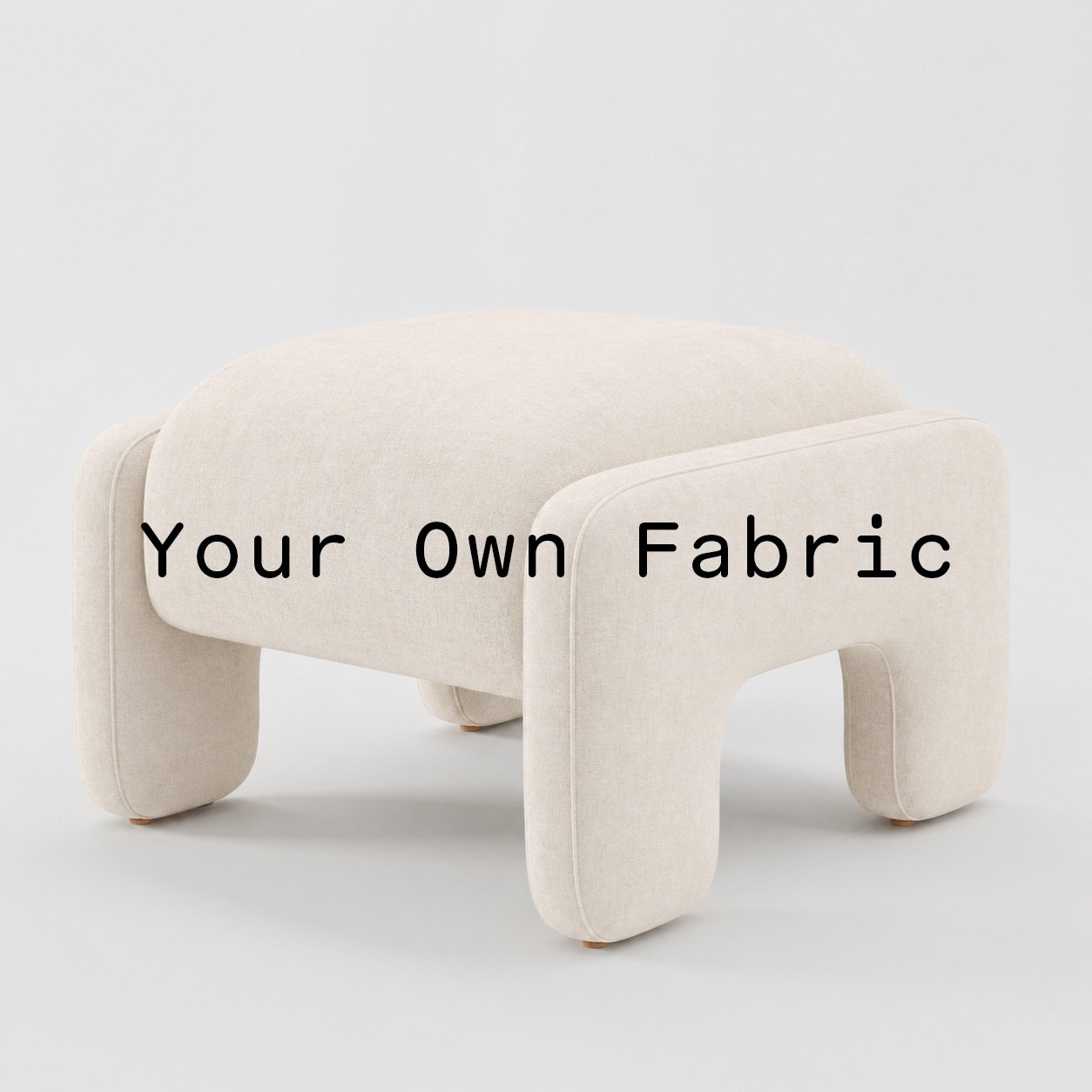 Diagonal view of the Inny footstool upholstered in customers own material calico cotton fabric.