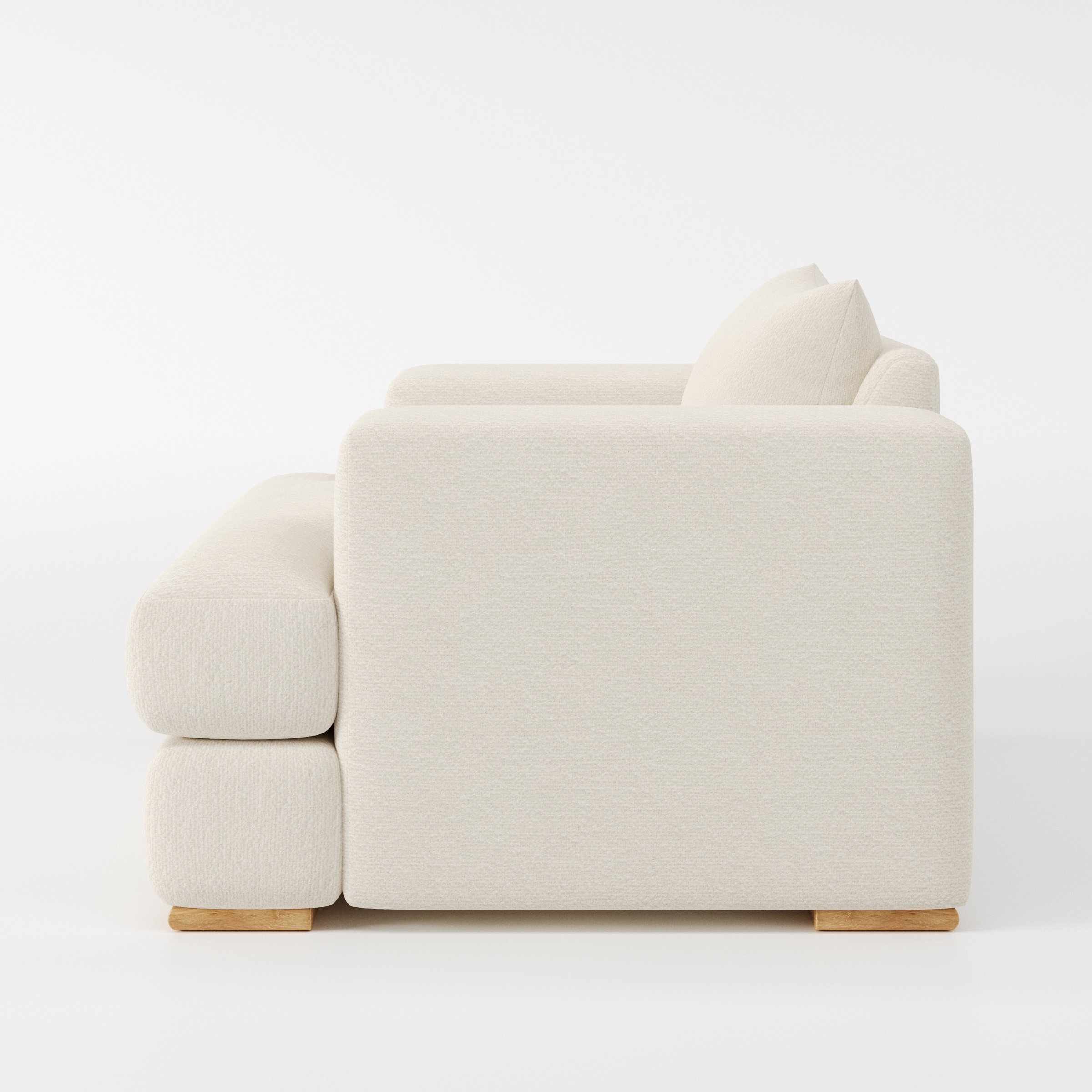 Fane armchair in Kilda Boucle Cream shown in side profile displaying proportions and overall silhouette.