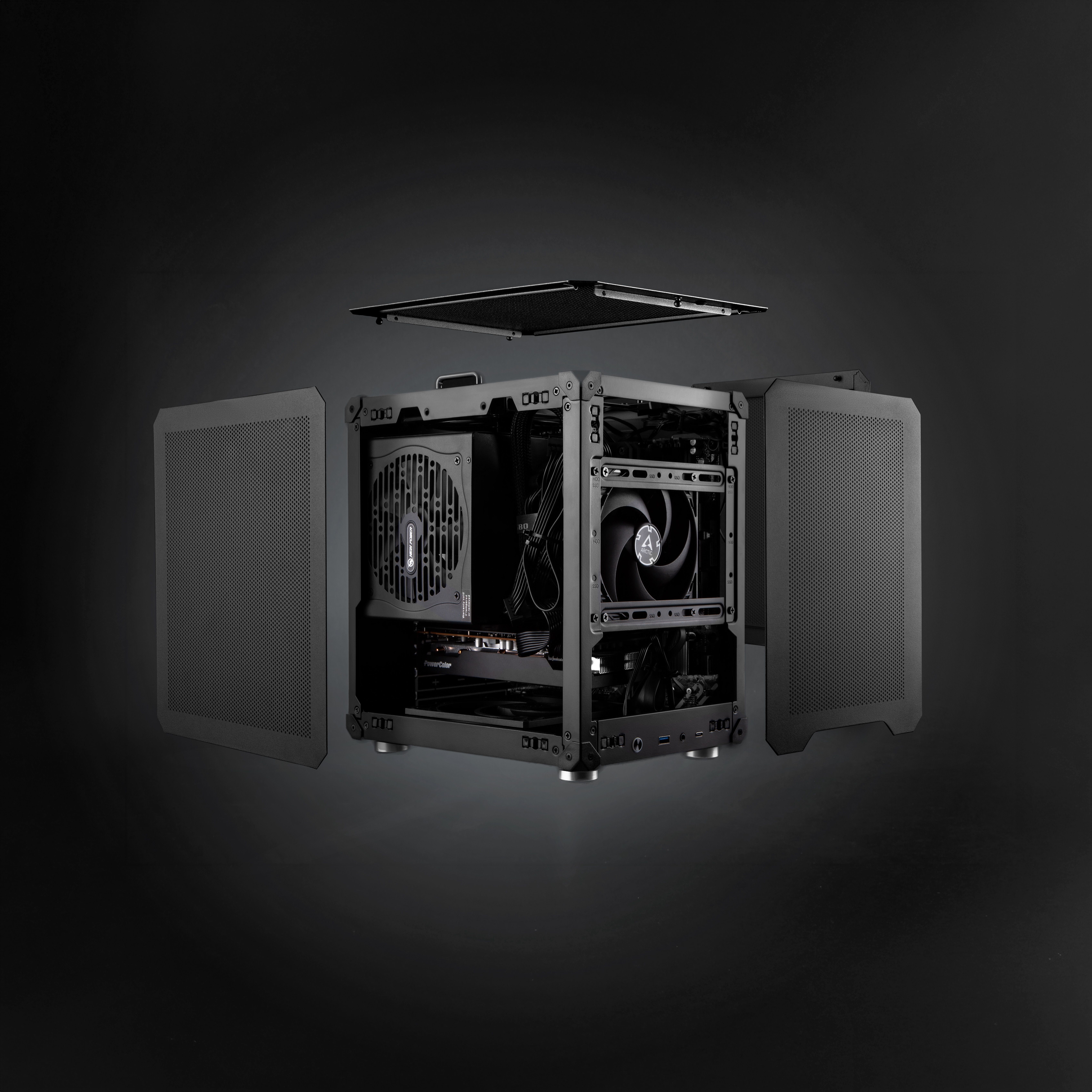 The open Jonsbo C6 frame with the side and top panels removed, showing the power supply, graphics card and fans packed into the micro-ATX layout.