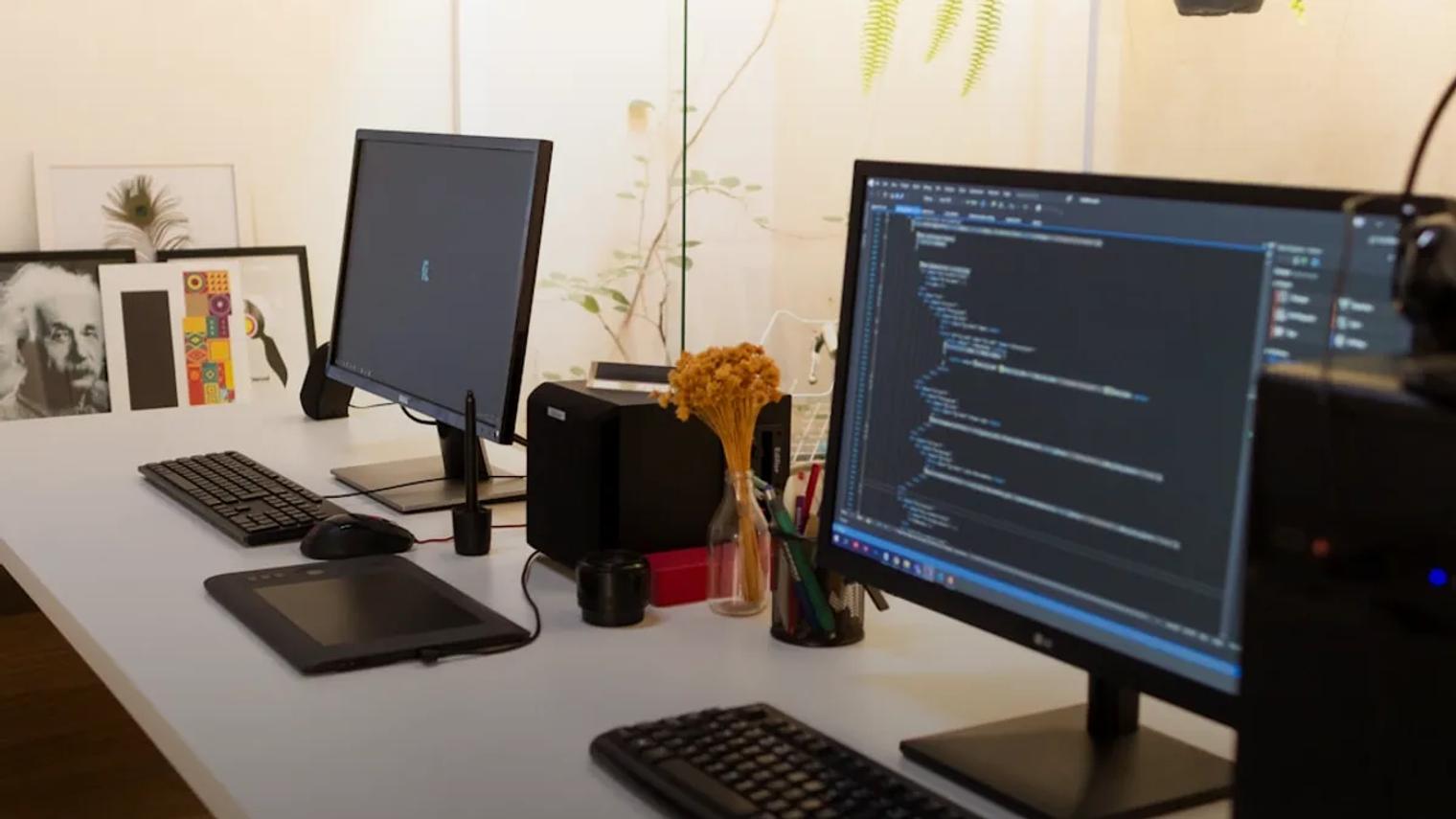 black flat screen computer monitor turned on beside black computer keyboard