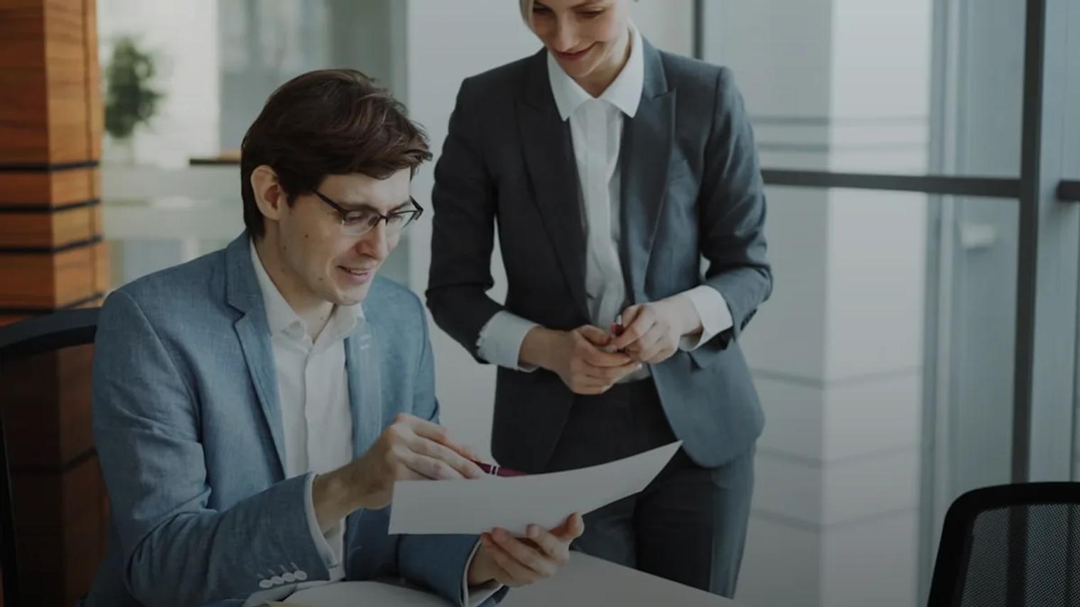 Two business people reviewing documents together