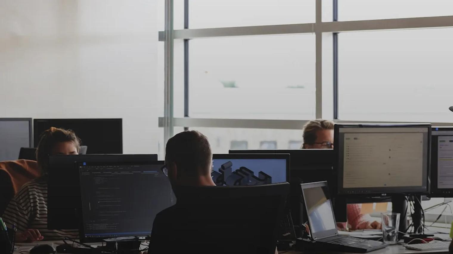 people sitting on chair in front of computer monitor