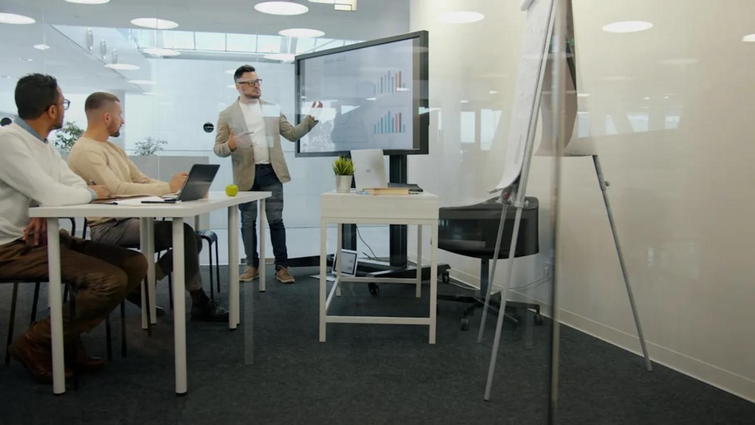 Man presenting to colleagues in a modern office