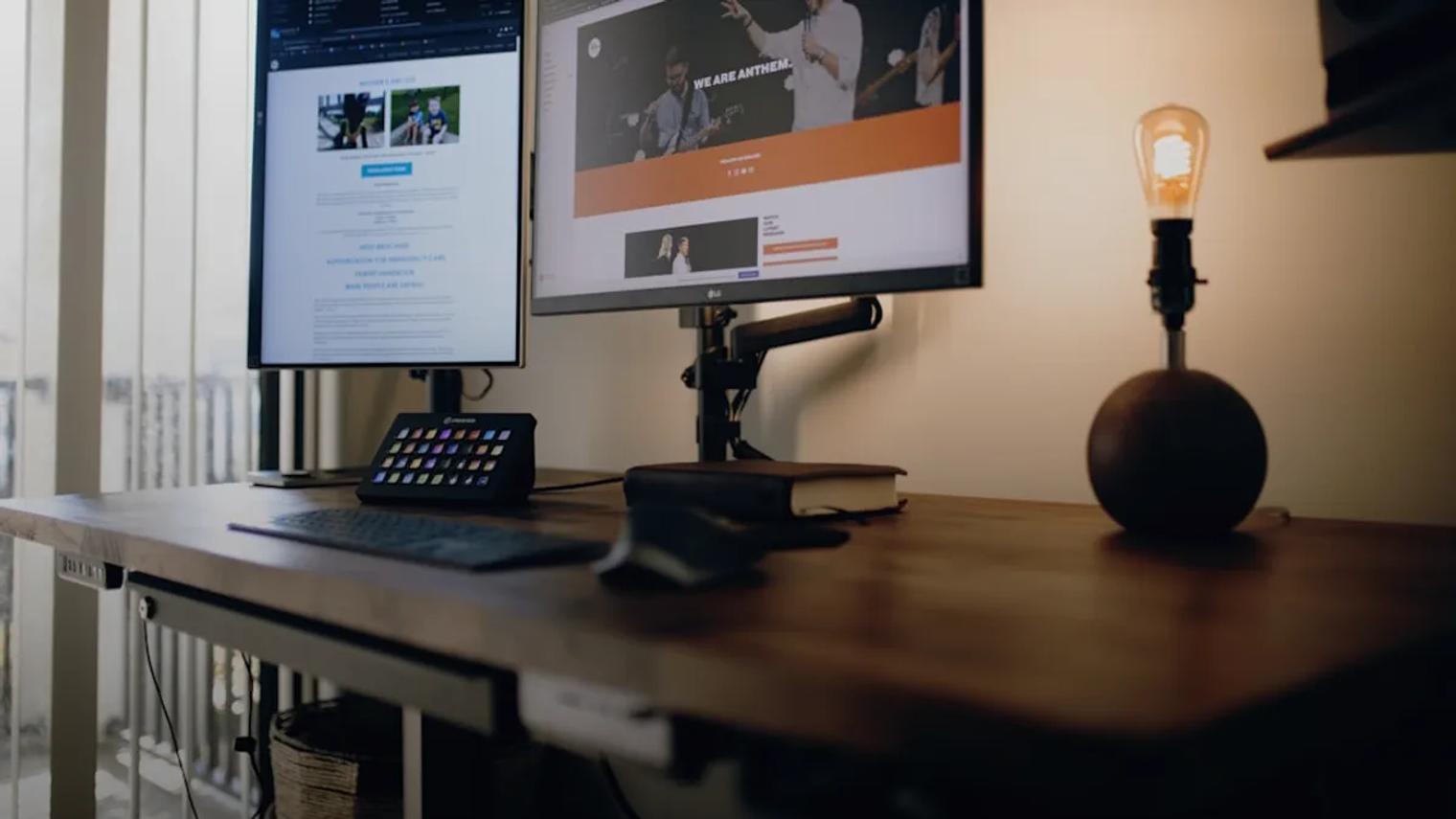 black flat screen computer monitor on brown wooden desk
