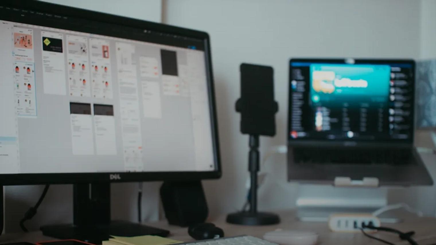 black flat screen computer monitor on brown wooden desk