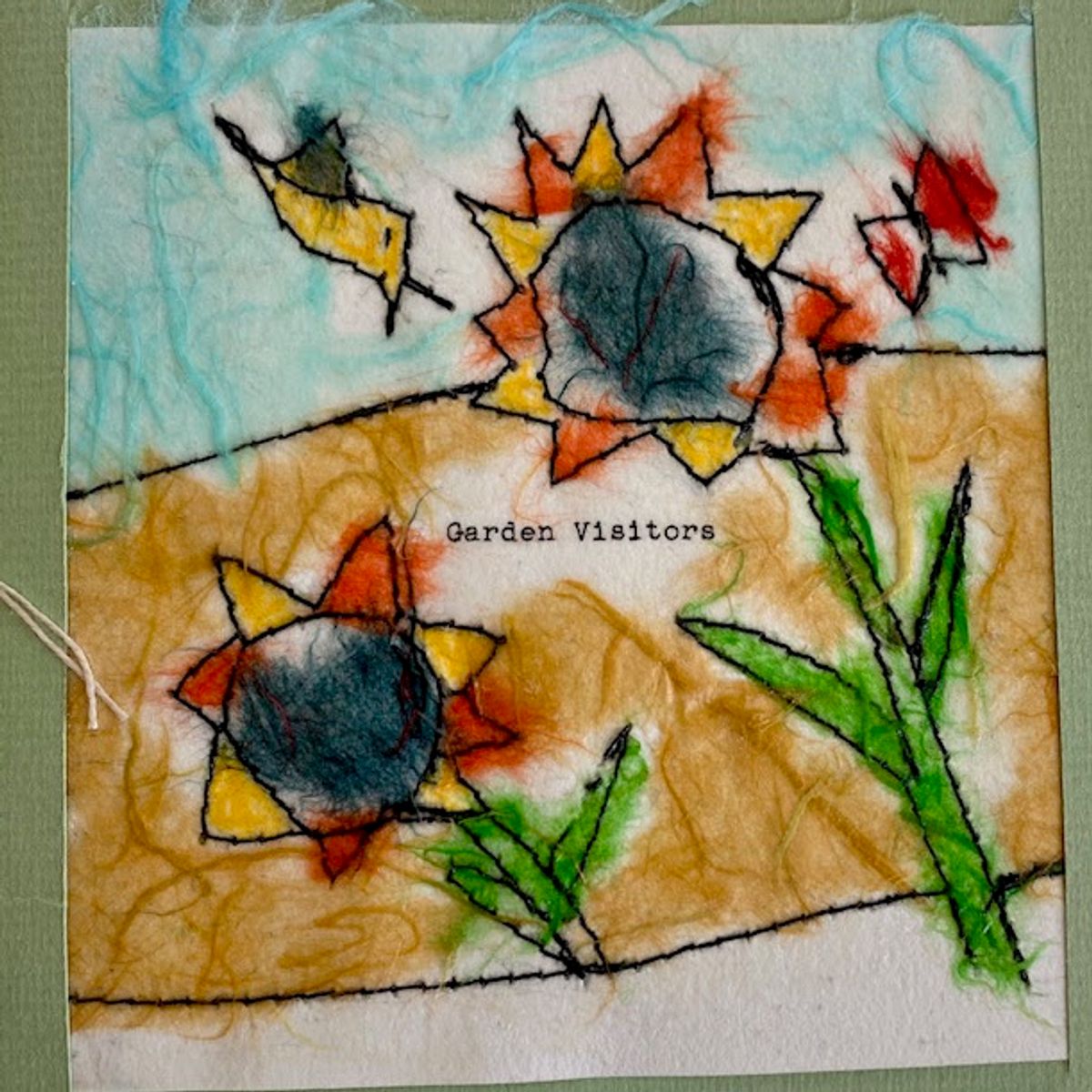 A felted panel with raw fibrous edges. Two sunflowers with grey centres rise from a warm ochre field against a white and aqua sky, stems and leaves worked in bright green. Typed words read "Garden Visitors".