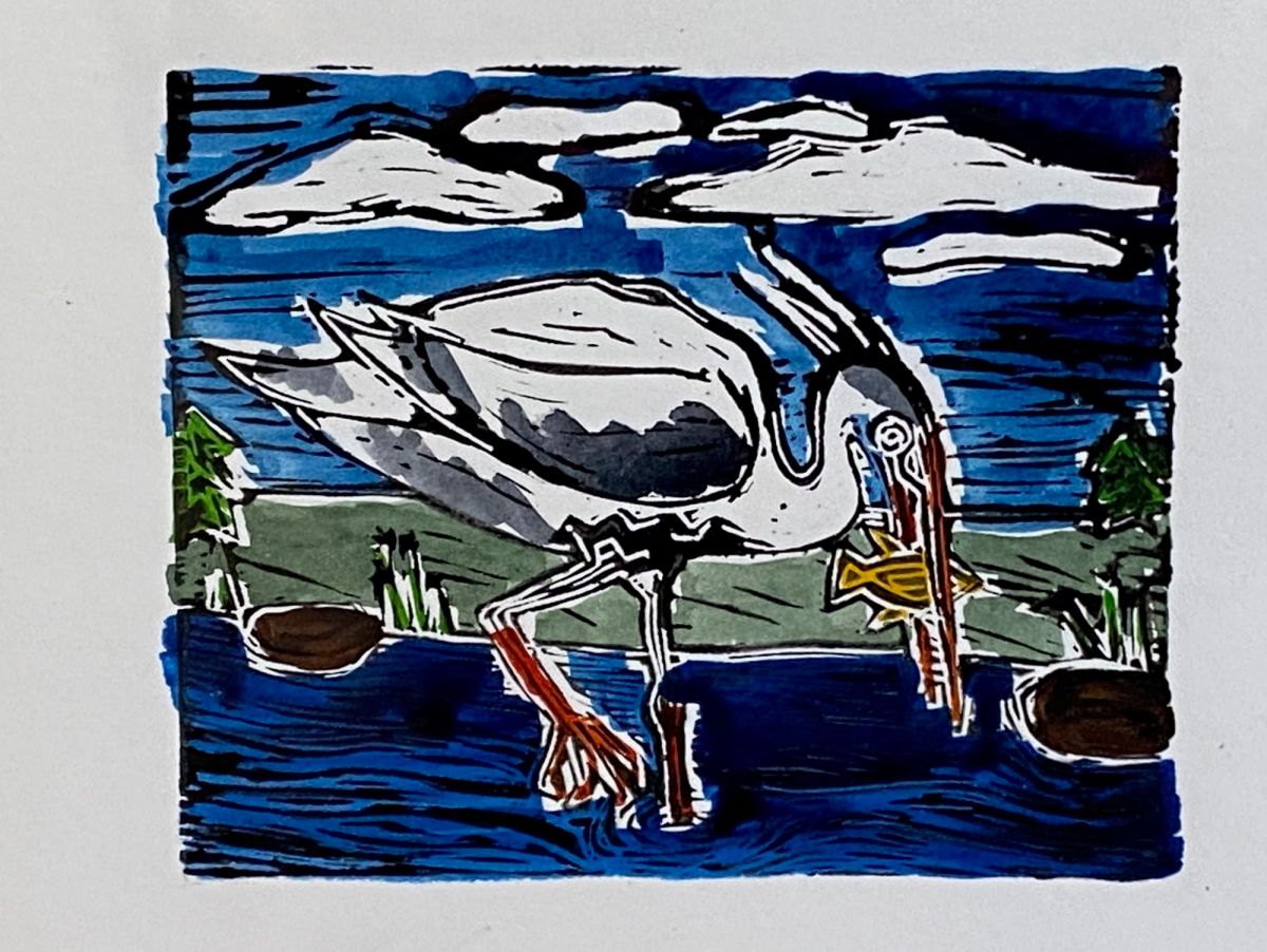 A hand-coloured linocut. A white heron bends to take a yellow fish, its rust-red legs in dark blue water. Heavy black cut-marks stripe the sky behind bold white clouds.